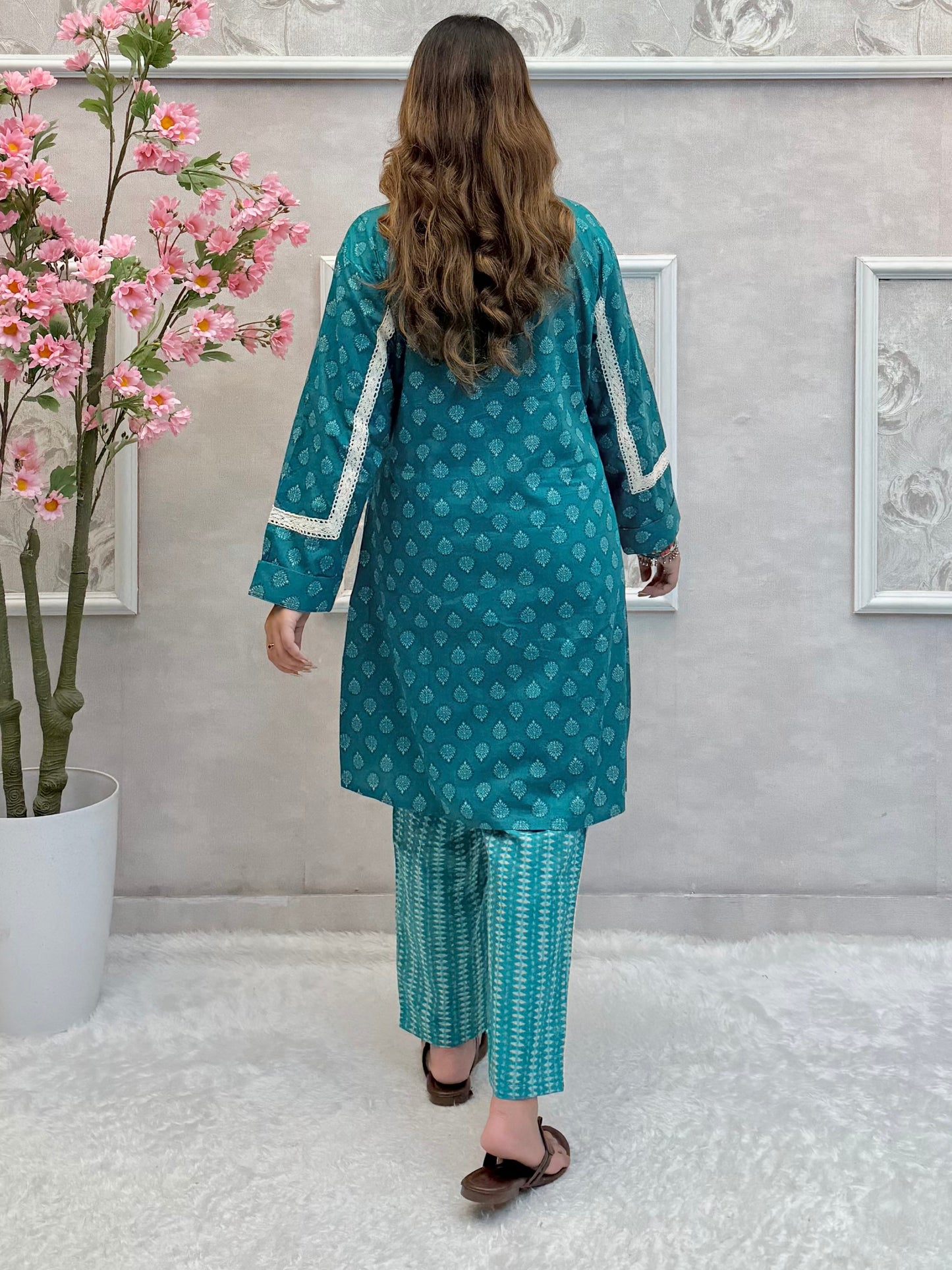 Model wearing a teal blue mulmul co-ord set with button-down kurta and printed straight pants – Designer Wear Collection.