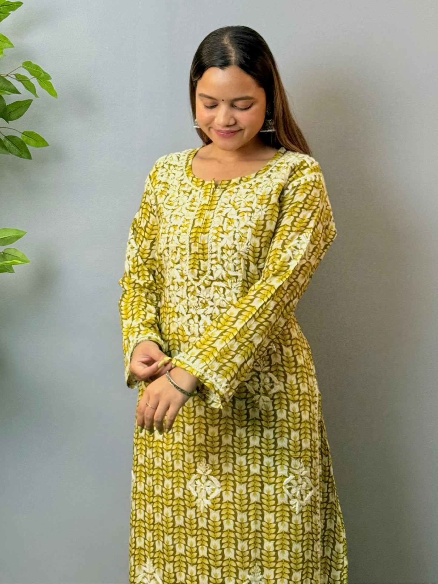 Model in olive green printed mulmul chikankari kurta with hand embroidery