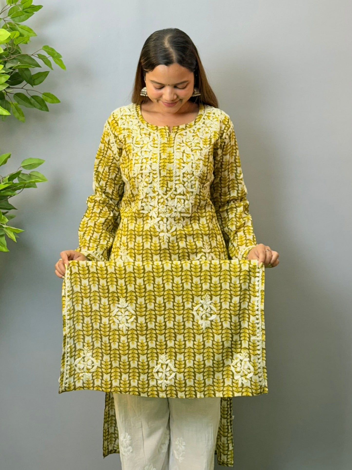 Model in olive green printed mulmul chikankari kurta with hand embroidery