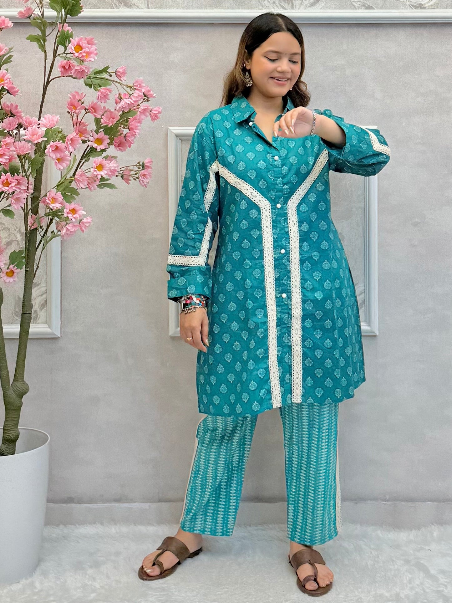 Model wearing a teal blue mulmul co-ord set with button-down kurta and printed straight pants – Designer Wear Collection.