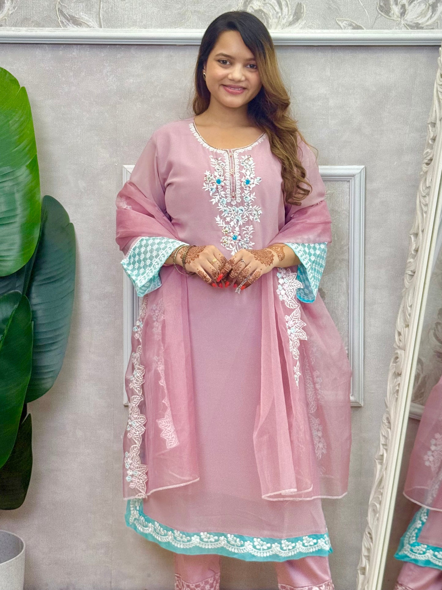 Model wearing a dusty pink georgette kurta with hand embroidery, lycra stretchable pants, and an organza dupatta – Designer Wear Collection.