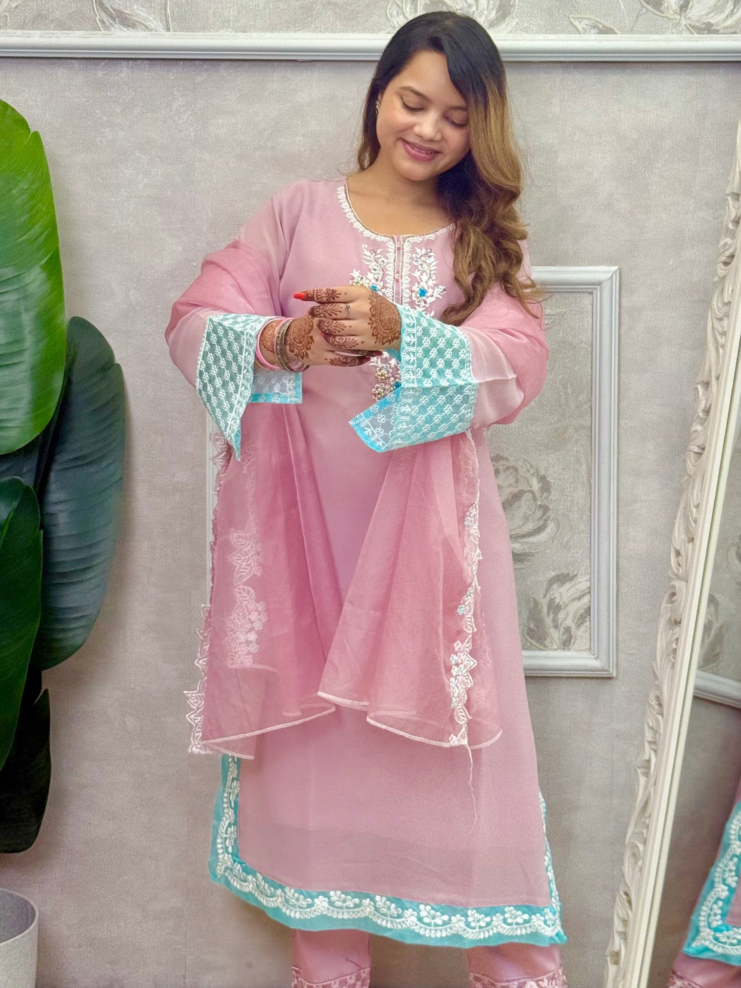 Model wearing a dusty pink georgette kurta with hand embroidery, lycra stretchable pants, and an organza dupatta – Designer Wear Collection.