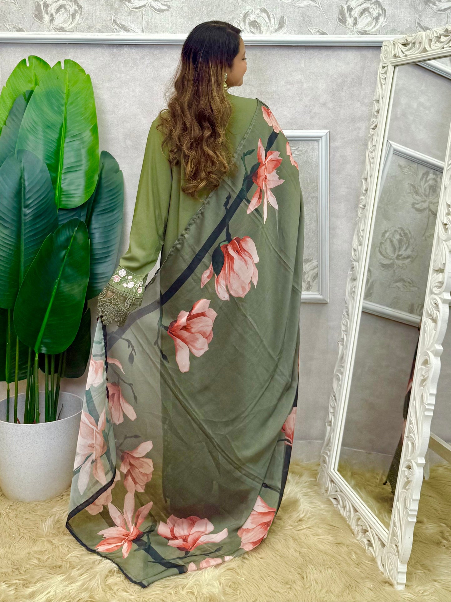 Model wearing an olive green rayon embroidered kurta with rayon pants and a floral printed georgette dupatta – Designer Wear Collection.