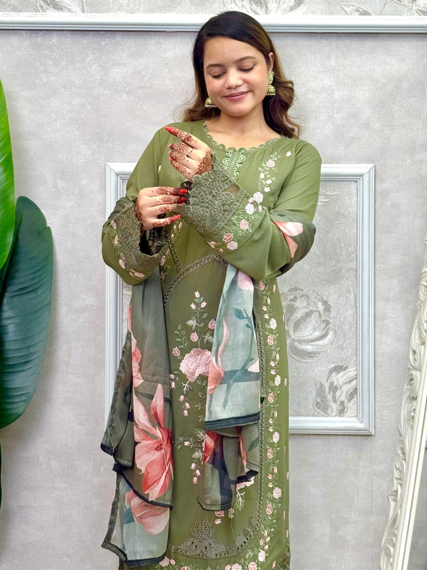 Model wearing an olive green rayon embroidered kurta with rayon pants and a floral printed georgette dupatta – Designer Wear Collection.