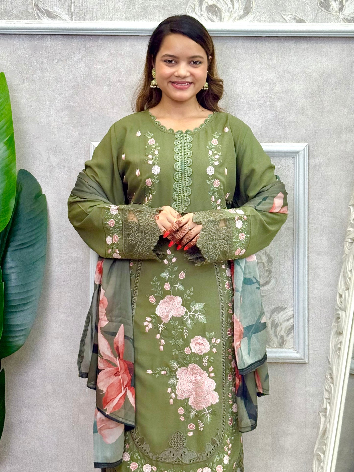 Model wearing an olive green rayon embroidered kurta with rayon pants and a floral printed georgette dupatta – Designer Wear Collection.