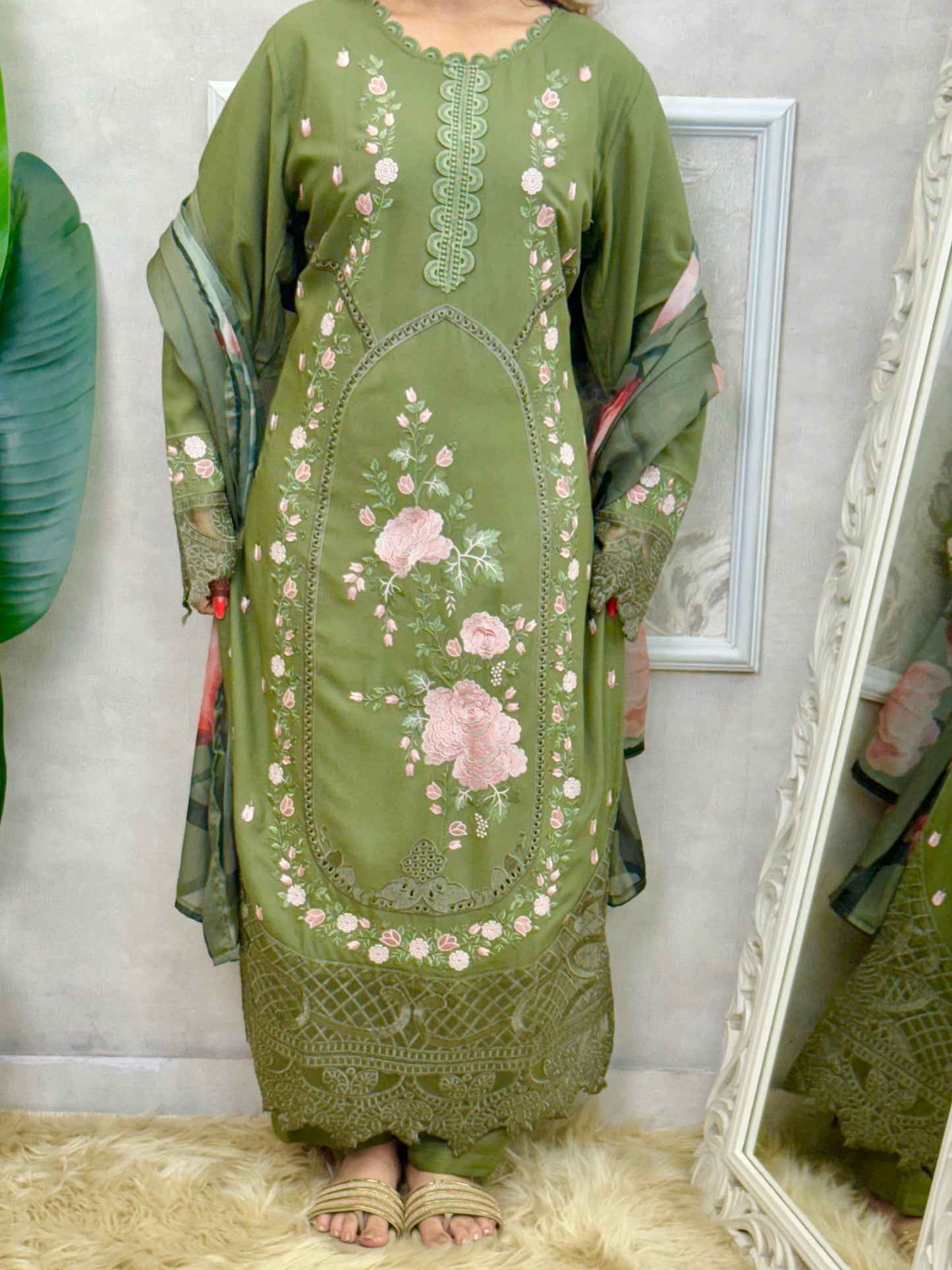 Model wearing an olive green rayon embroidered kurta with rayon pants and a floral printed georgette dupatta – Designer Wear Collection.
