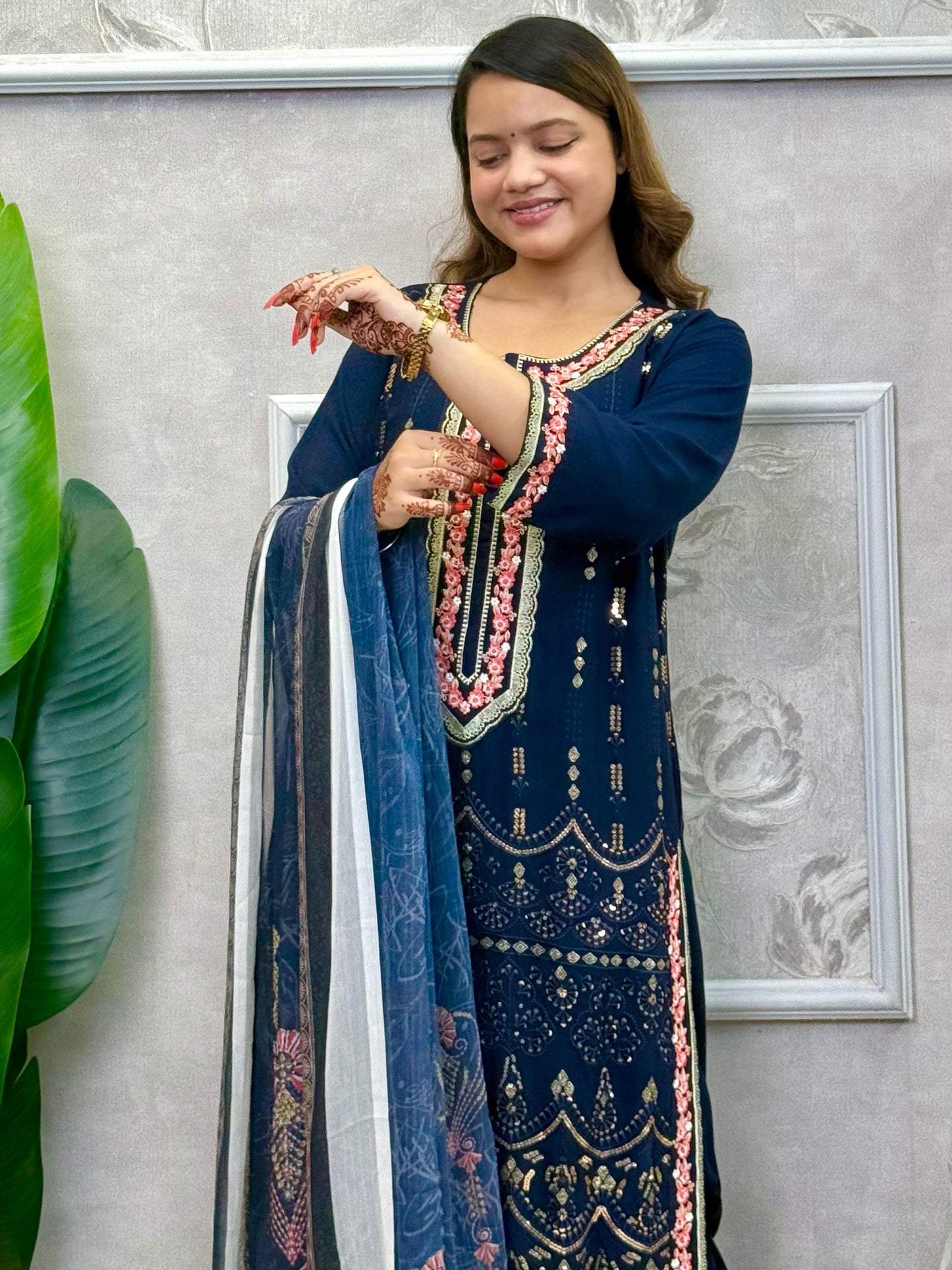 Model wearing a navy blue rayon kurta with intricate machine embroidery, paired with rayon pants and a chiffon dupatta – Designer Wear Collection.