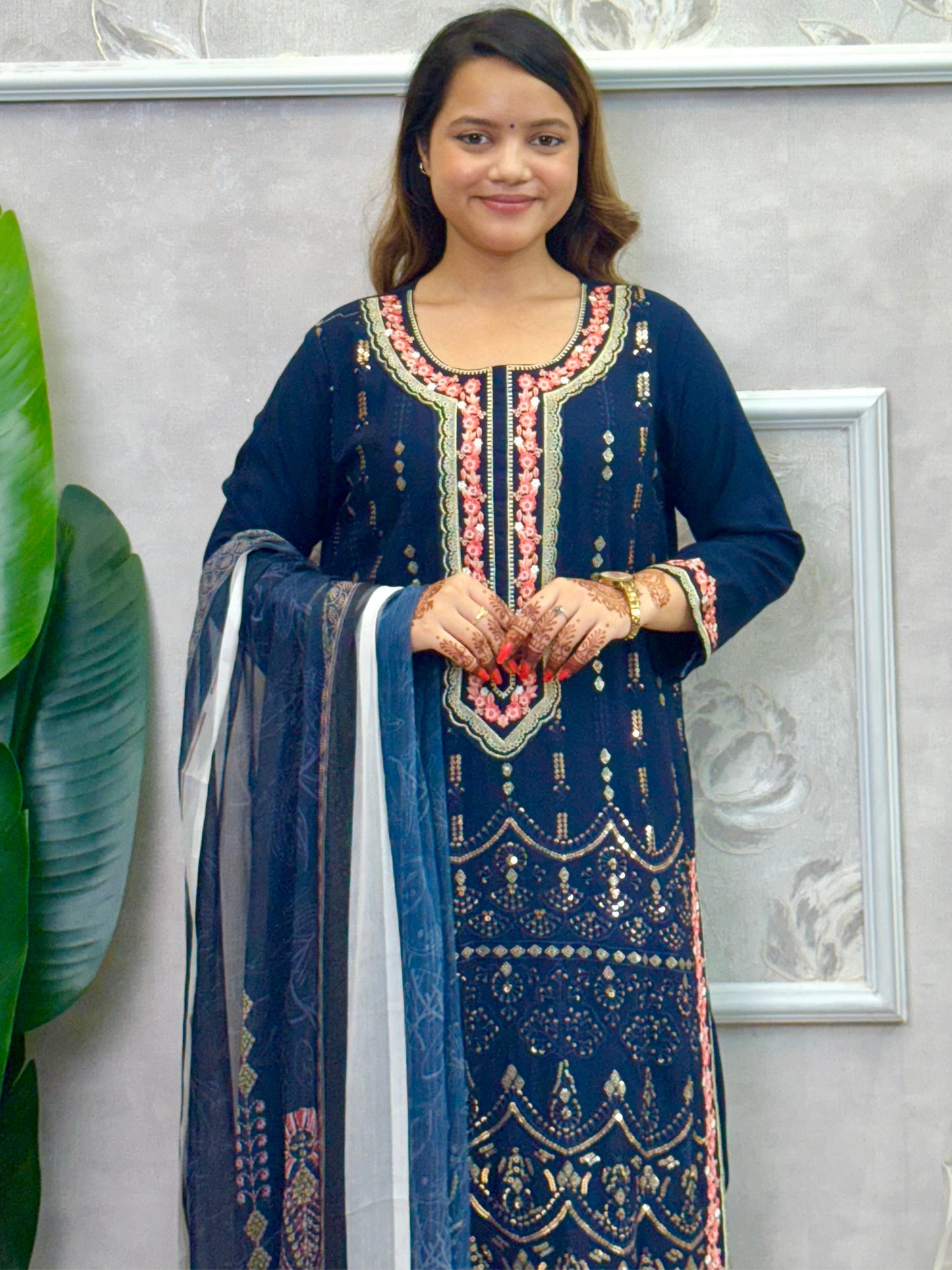 Model wearing a navy blue rayon kurta with intricate machine embroidery, paired with rayon pants and a chiffon dupatta – Designer Wear Collection.