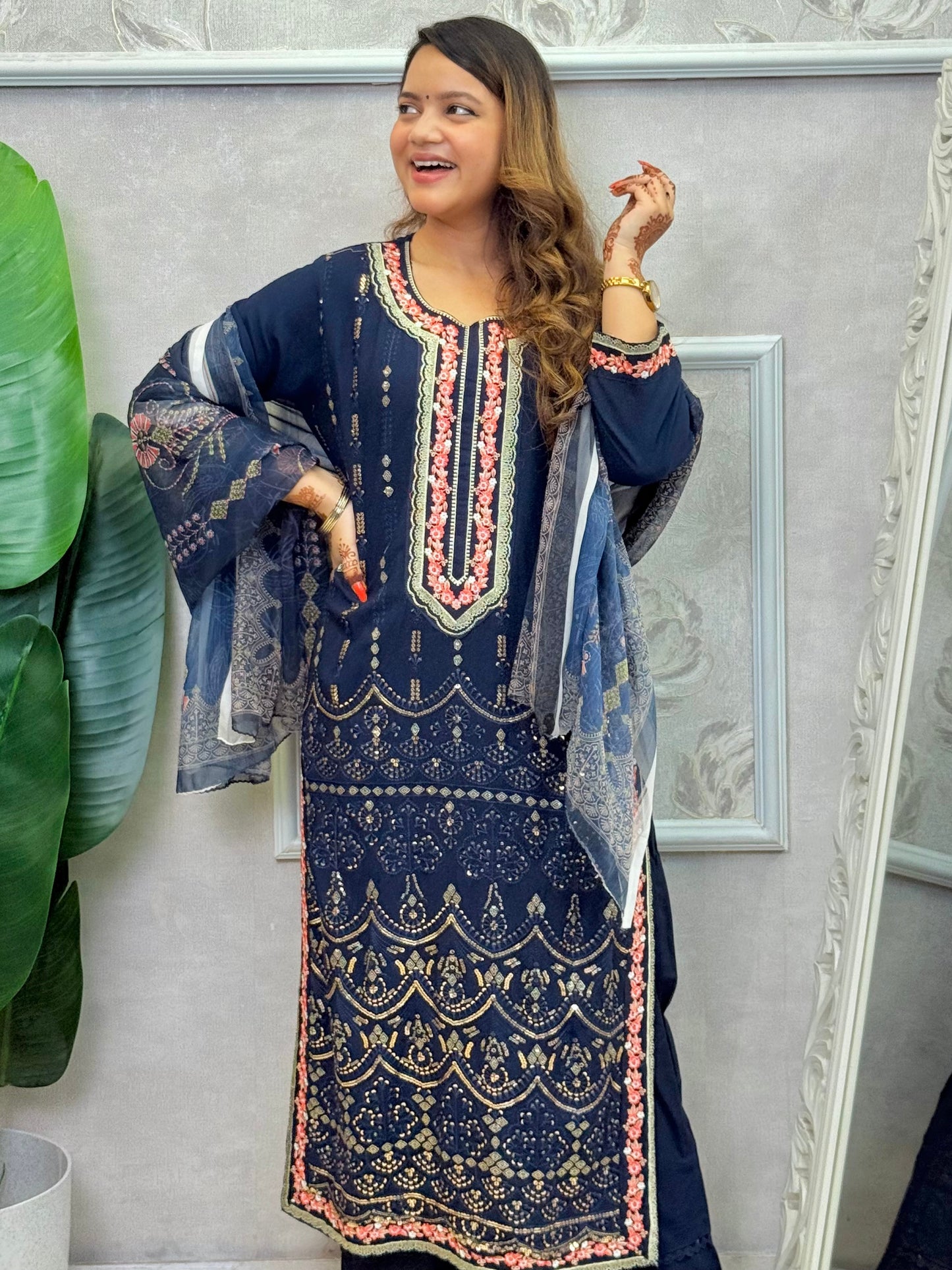 Model wearing a navy blue rayon kurta with intricate machine embroidery, paired with rayon pants and a chiffon dupatta – Designer Wear Collection.