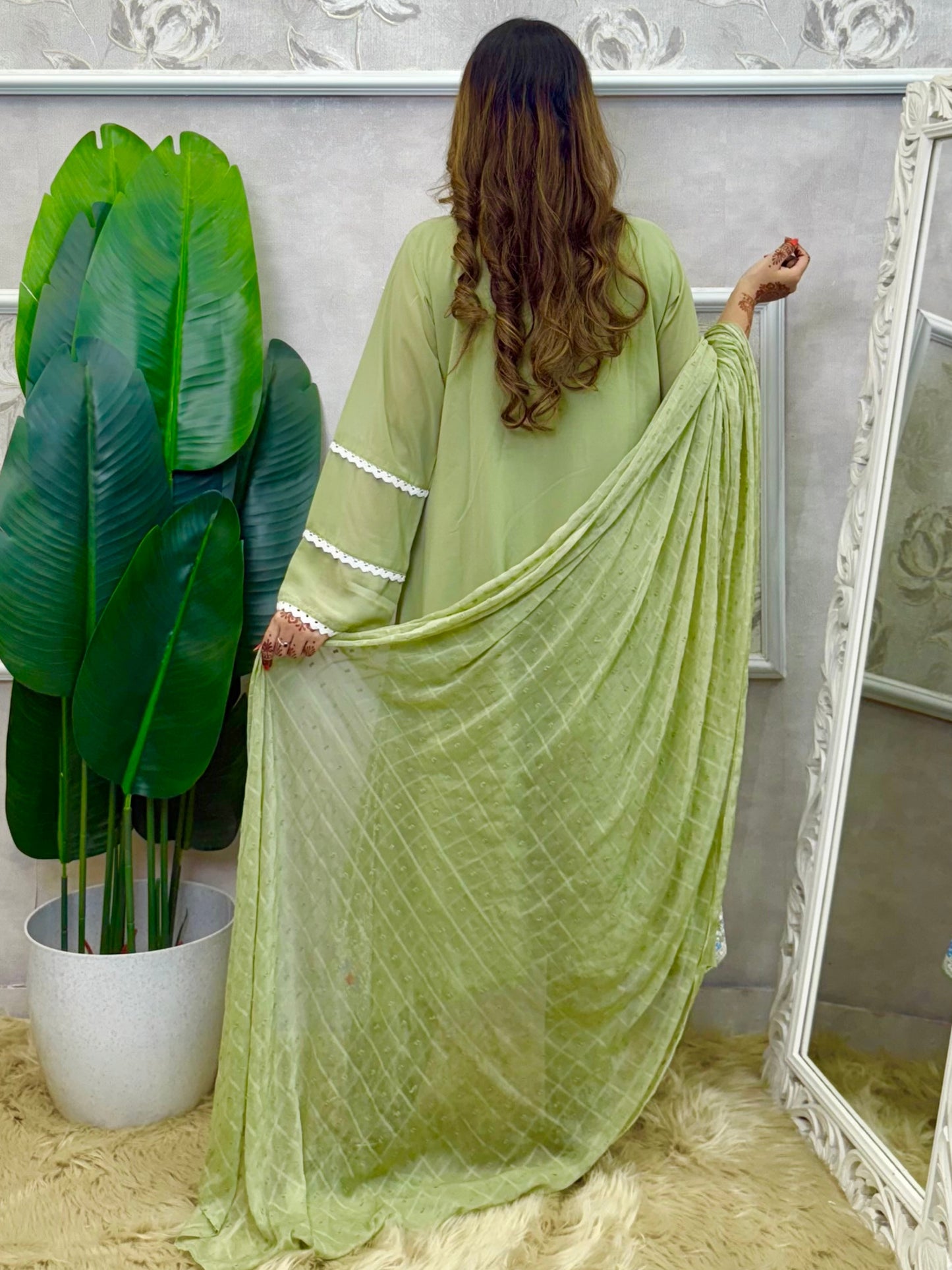 Model wearing a sage green embroidered georgette kurta with lycra stretchable pants and a chiffon dupatta – Designer Wear Collection.
