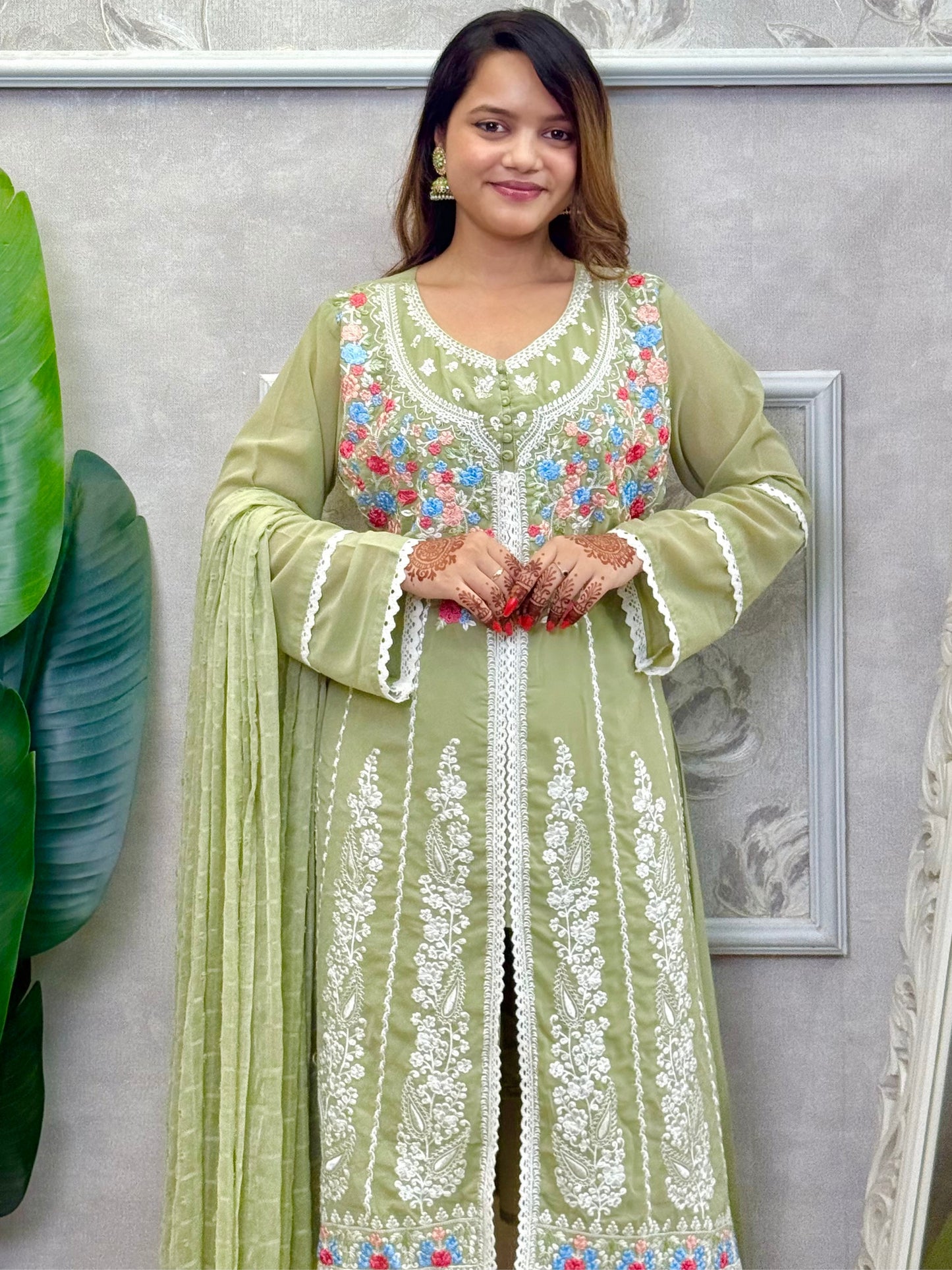 Model wearing a sage green embroidered georgette kurta with lycra stretchable pants and a chiffon dupatta – Designer Wear Collection.
