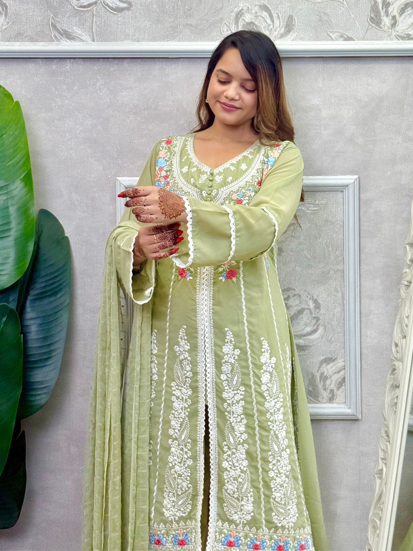 Model wearing a sage green embroidered georgette kurta with lycra stretchable pants and a chiffon dupatta – Designer Wear Collection.