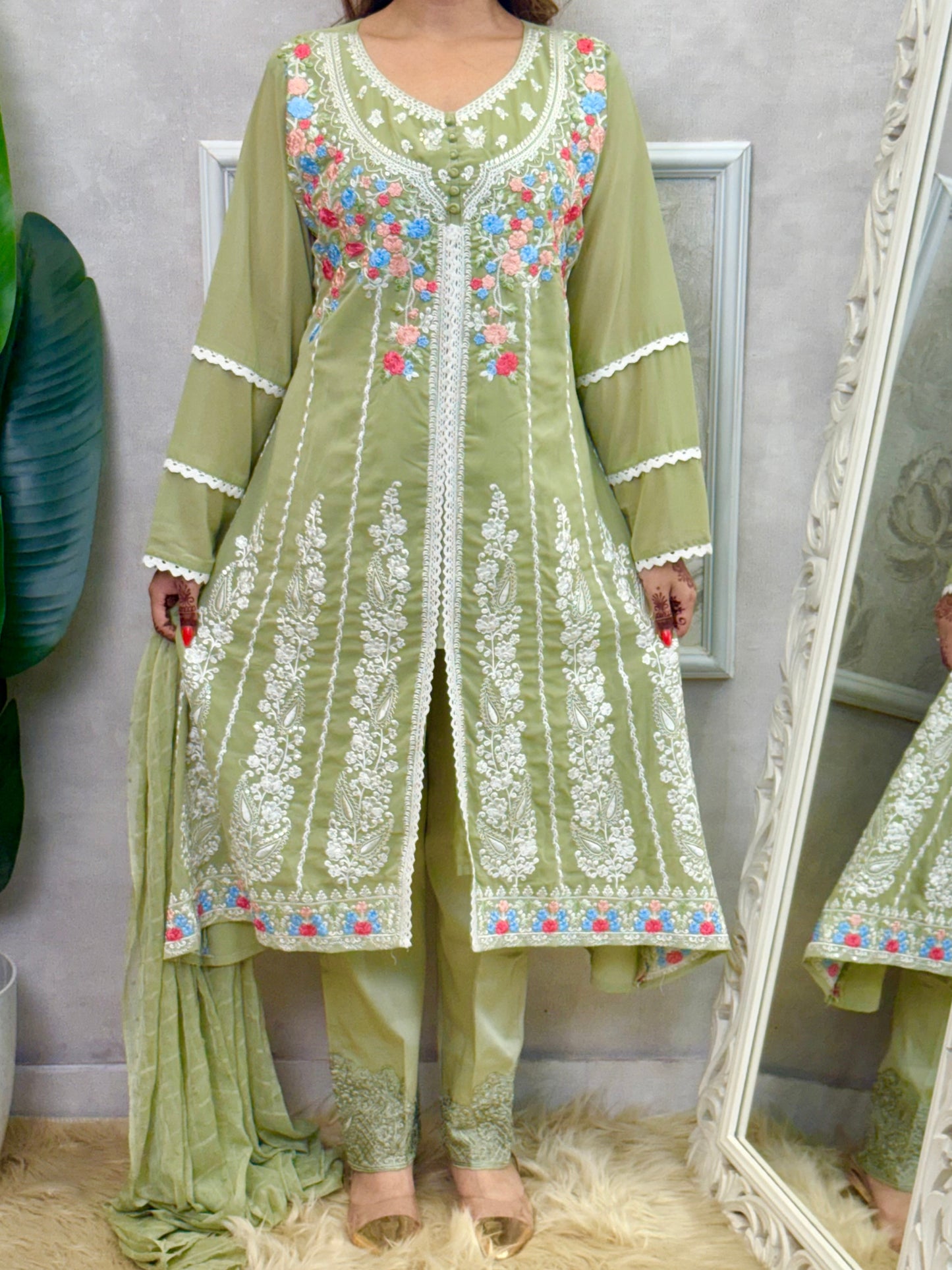 Model wearing a sage green embroidered georgette kurta with lycra stretchable pants and a chiffon dupatta – Designer Wear Collection.