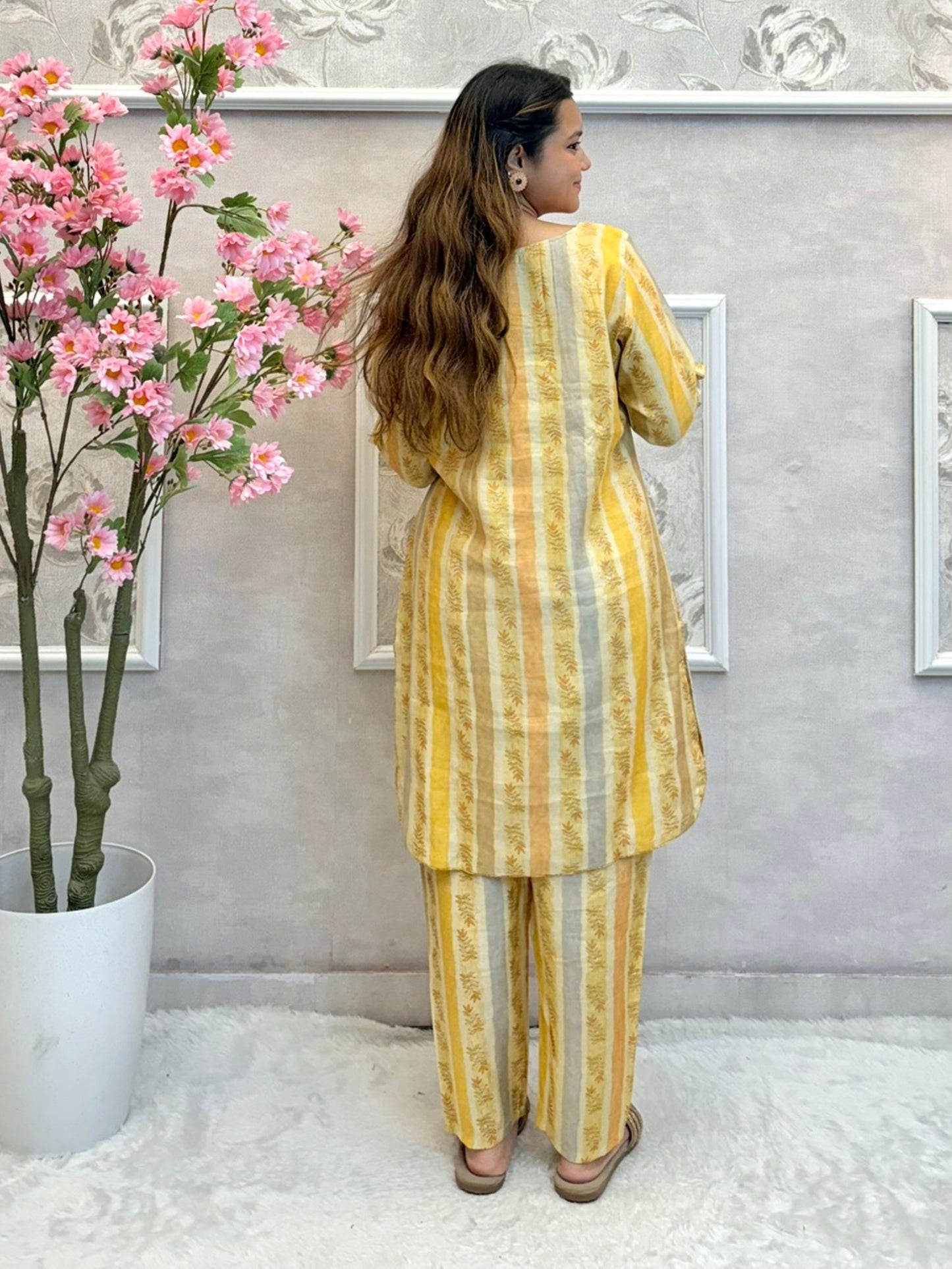 Yellow muslin printed co-ord set with floral embellishments and striped kurta and pants
