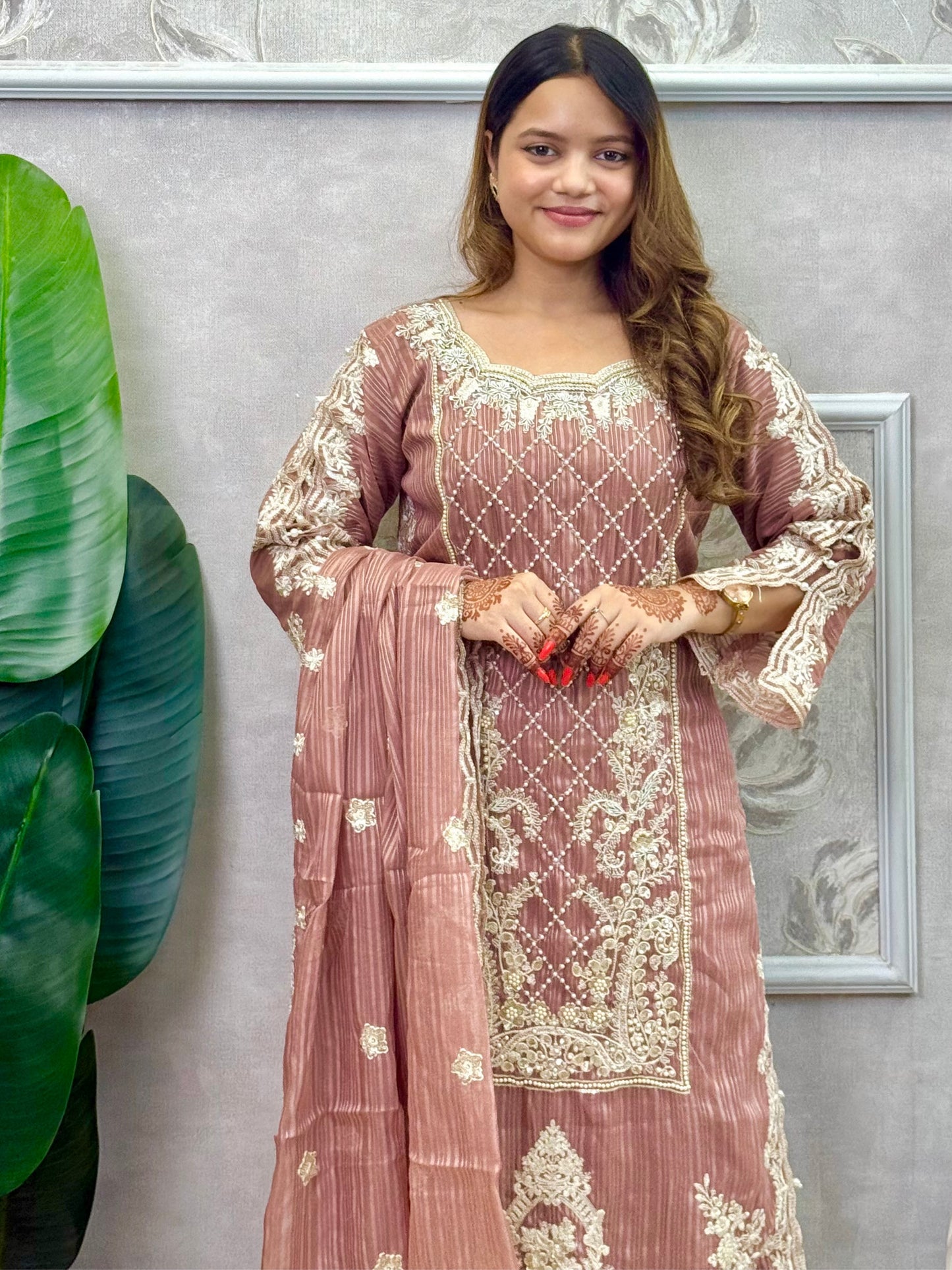 Model wearing a dusty brown soft organza kurta with hand embroidery, lycra stretchable pants, and a matching embroidered soft organza dupatta – Designer Wear Collection.