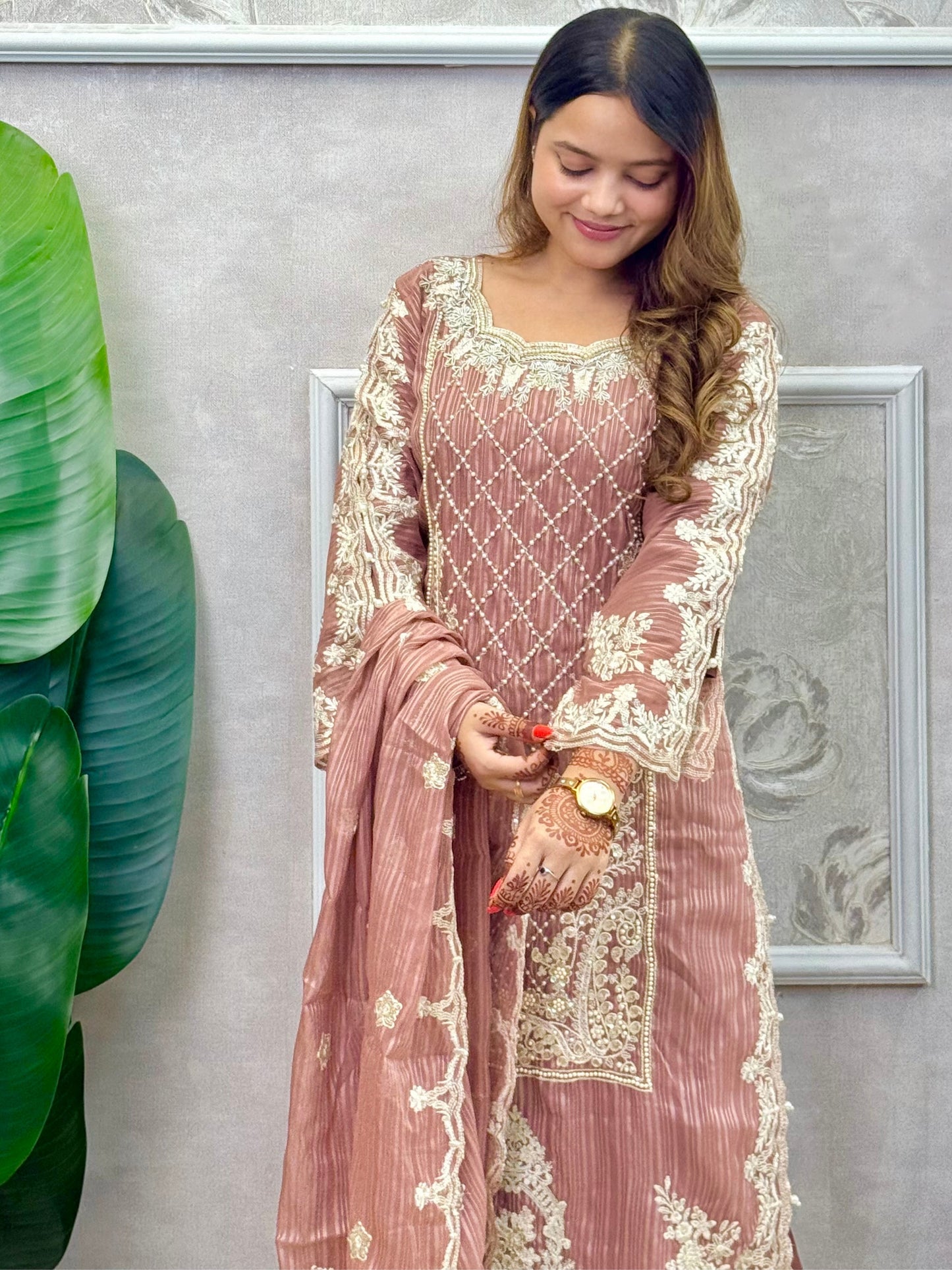 Model wearing a dusty brown soft organza kurta with hand embroidery, lycra stretchable pants, and a matching embroidered soft organza dupatta – Designer Wear Collection.