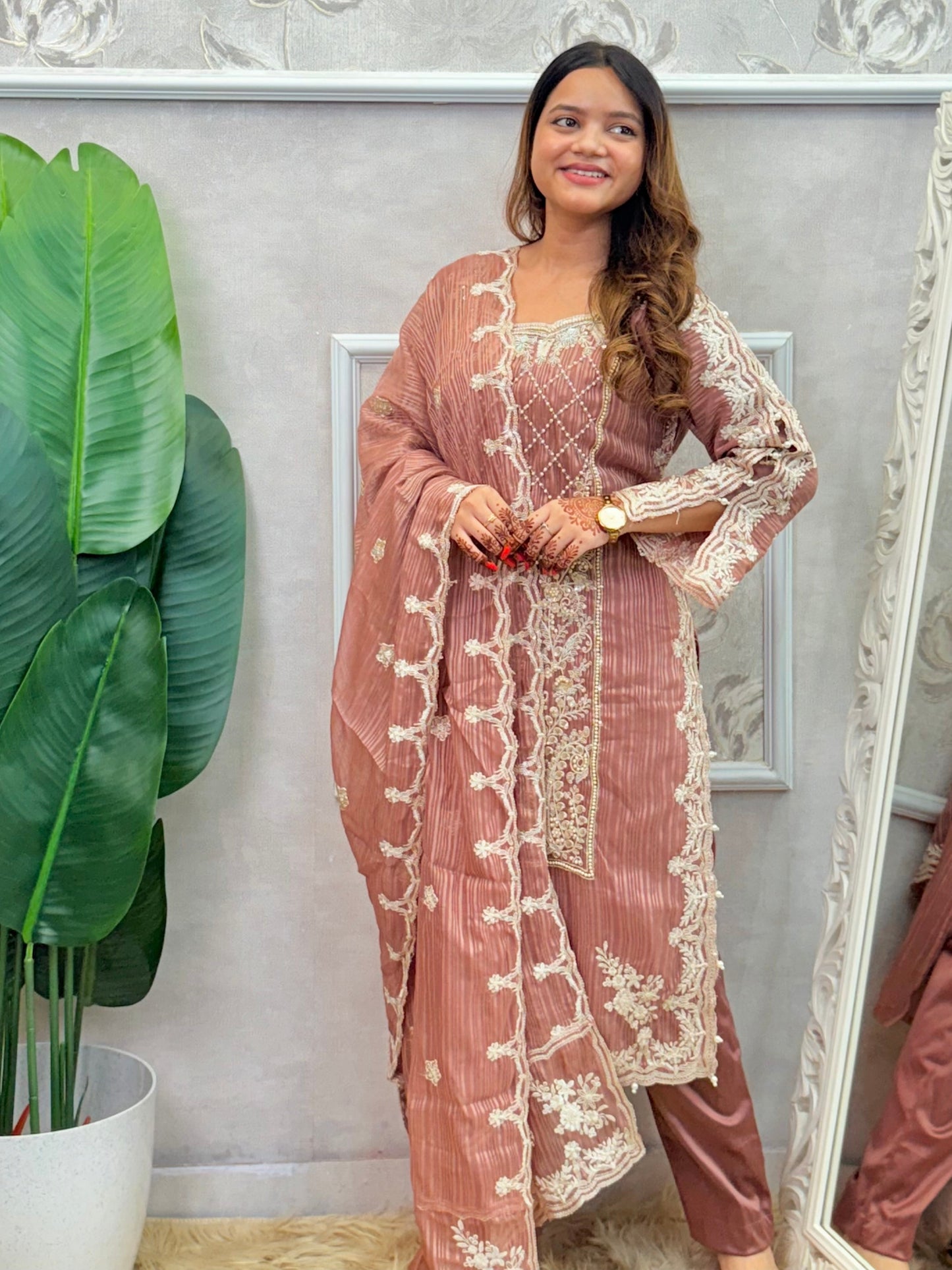 Model wearing a dusty brown soft organza kurta with hand embroidery, lycra stretchable pants, and a matching embroidered soft organza dupatta – Designer Wear Collection.