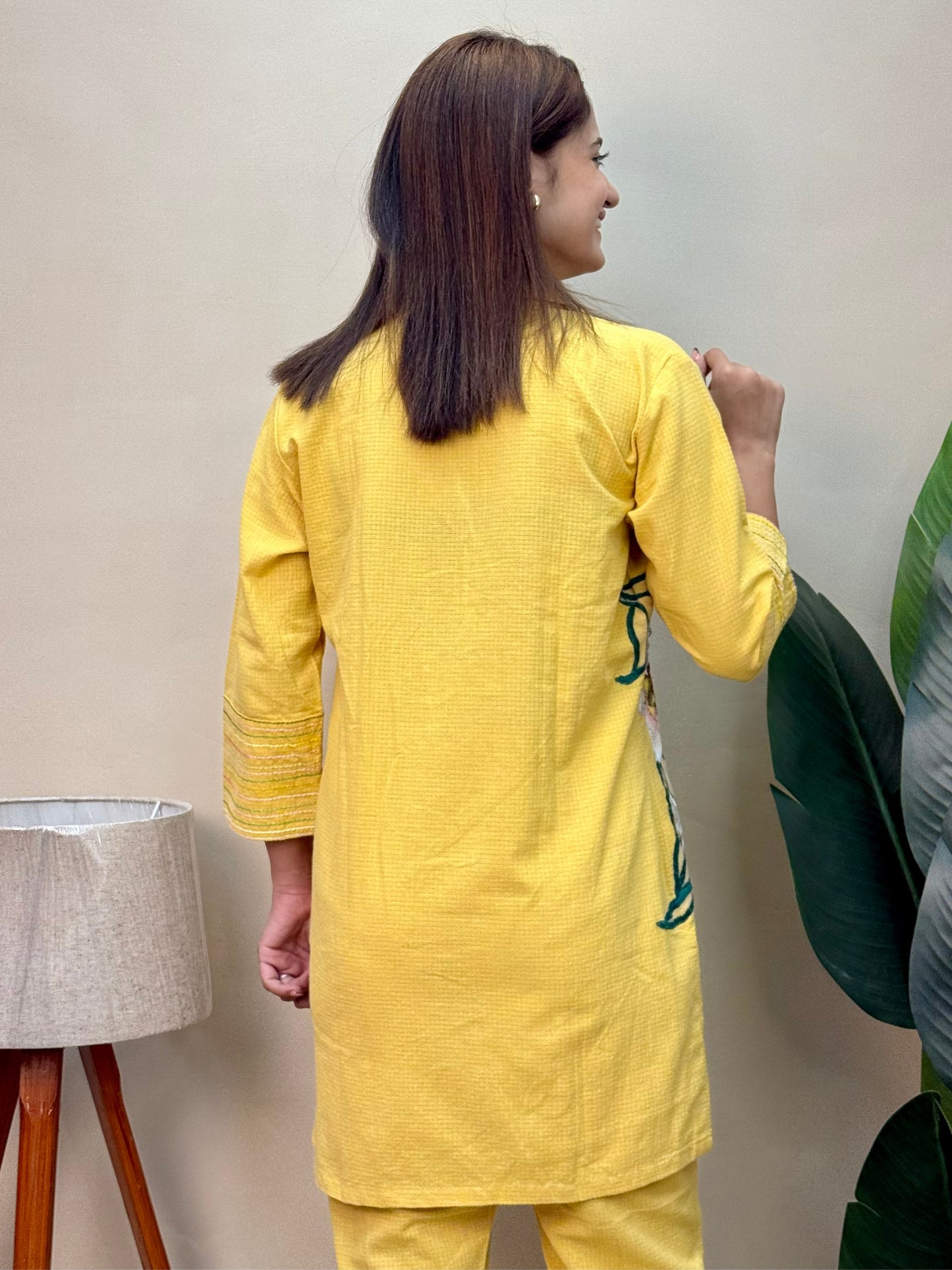 Model wearing a sunflower yellow cotton co-ord set with embroidered kurta and matching cotton pants – Designer Wear Collection.