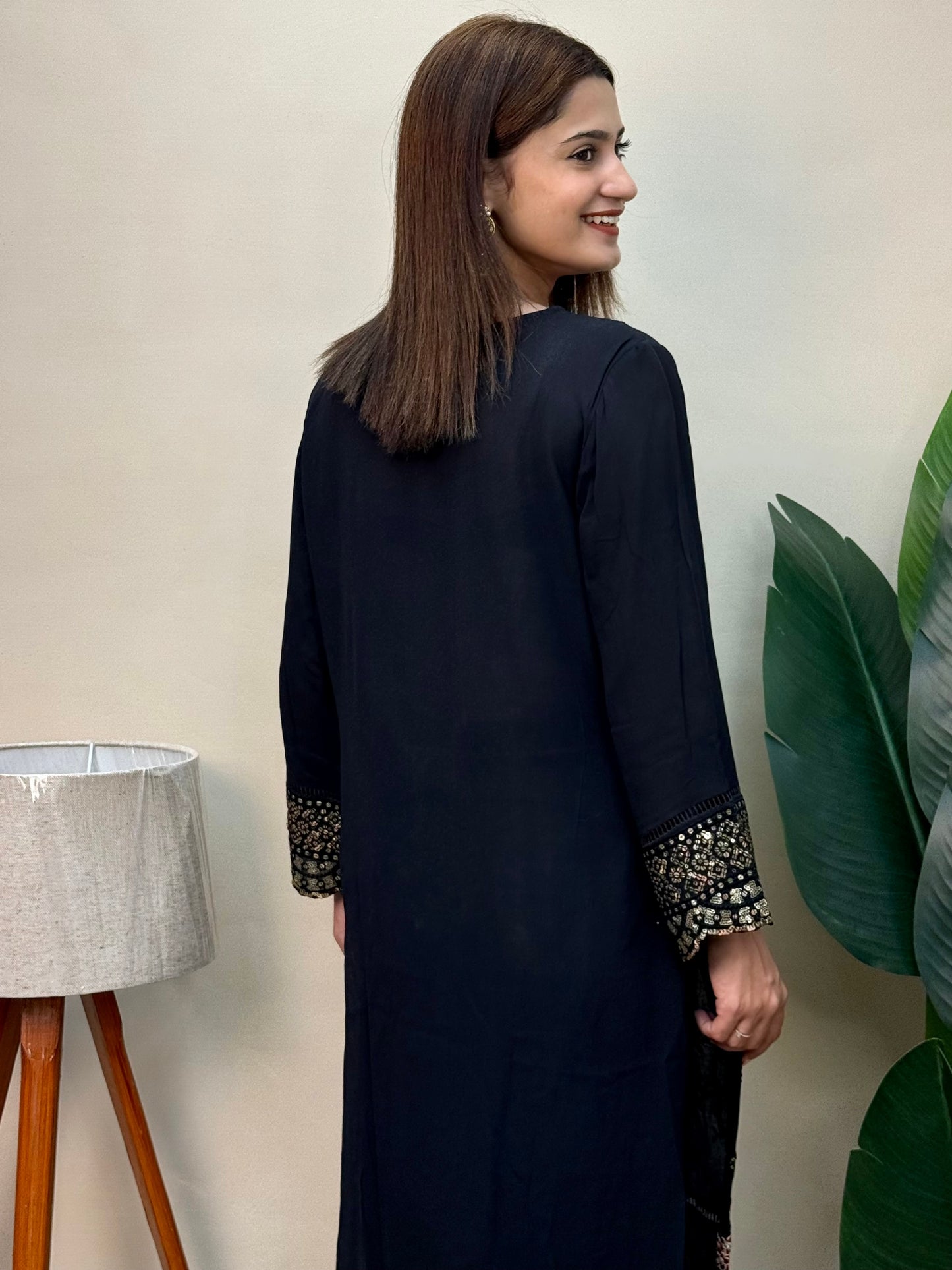 Model wearing a black rayon embroidered kurta with rayon pants and a printed chiffon dupatta – Designer Wear Collection.