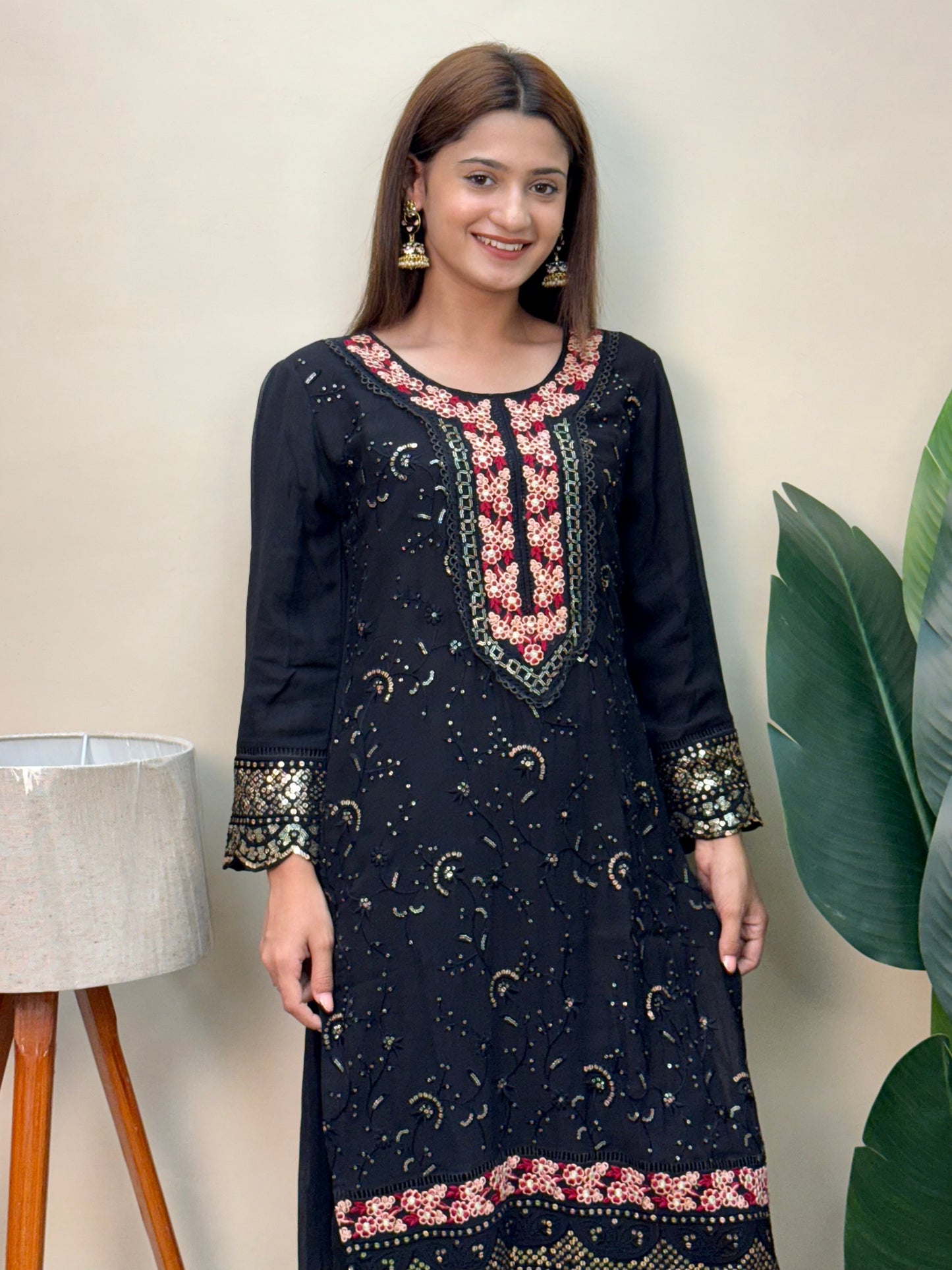 Model wearing a black rayon embroidered kurta with rayon pants and a printed chiffon dupatta – Designer Wear Collection.