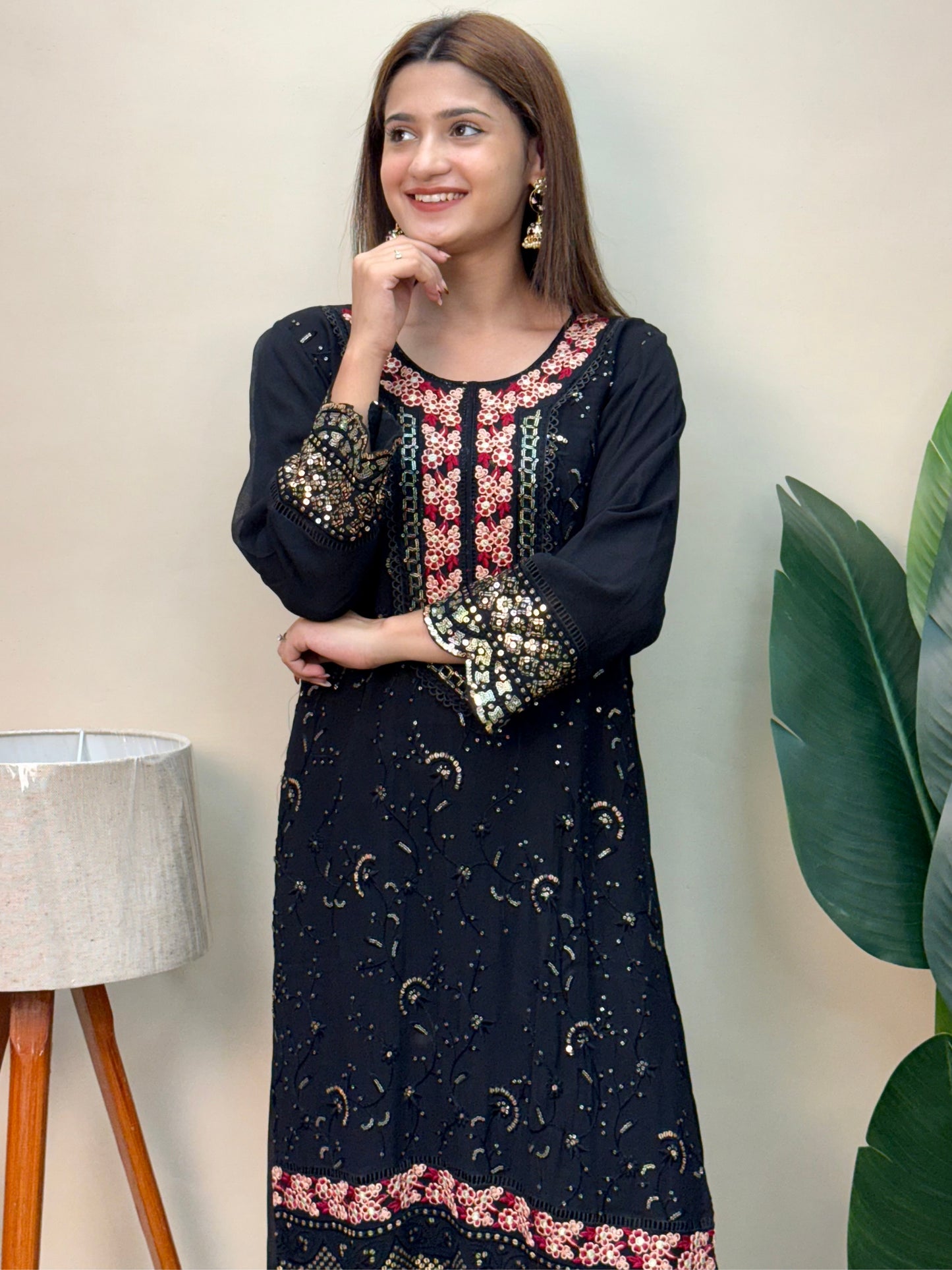 Model wearing a black rayon embroidered kurta with rayon pants and a printed chiffon dupatta – Designer Wear Collection.