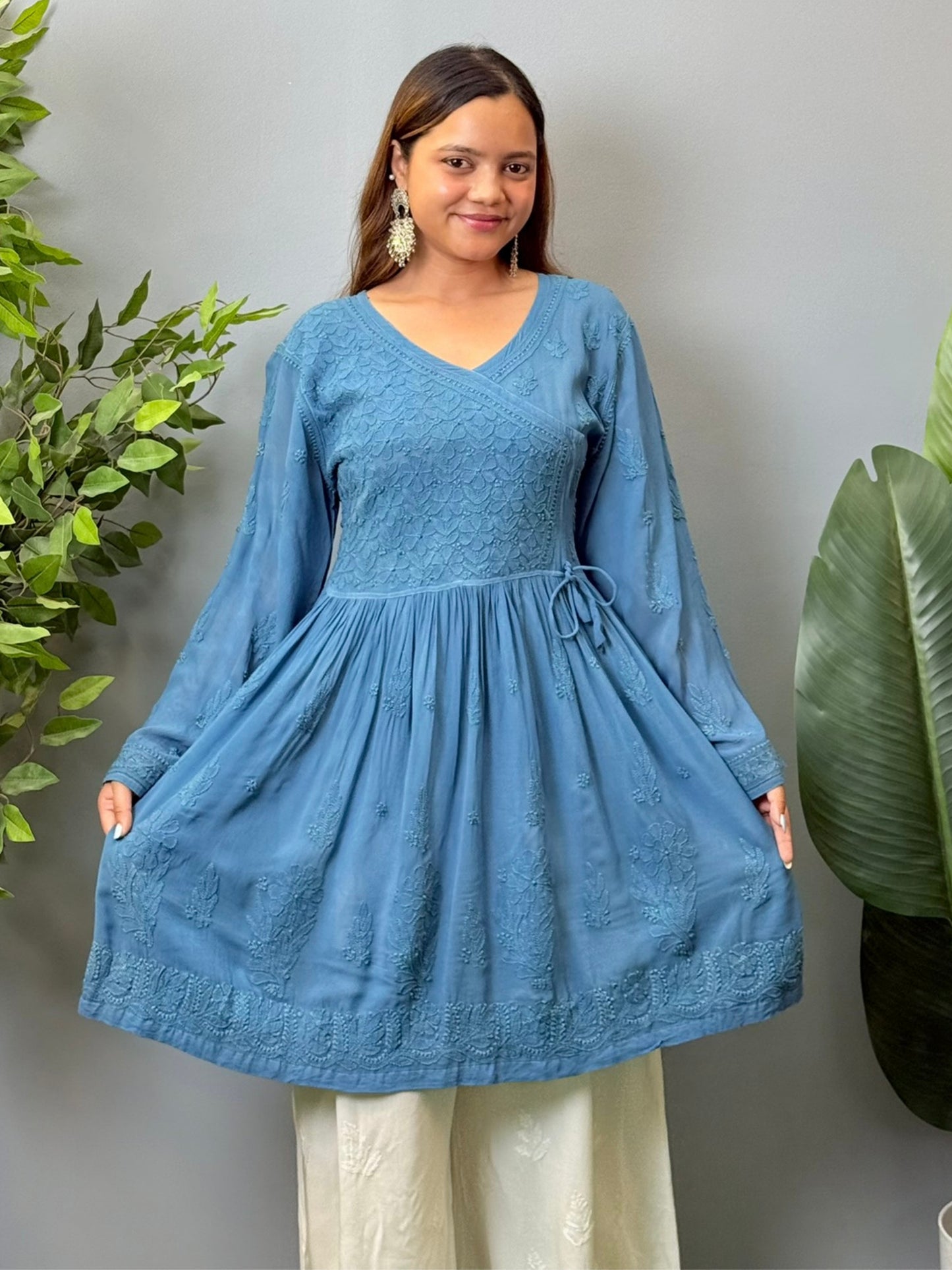 Model wearing a teal blue viscose angrakha-style short kurta with Lucknowi chikankari embroidery and side tie-up.