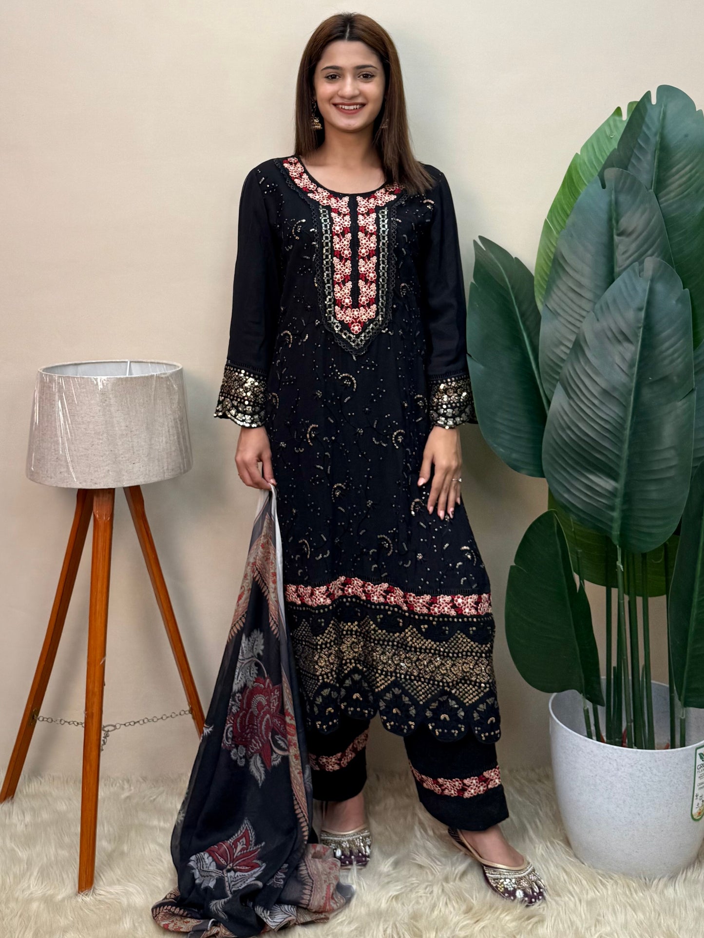Model wearing a black rayon embroidered kurta with rayon pants and a printed chiffon dupatta – Designer Wear Collection.