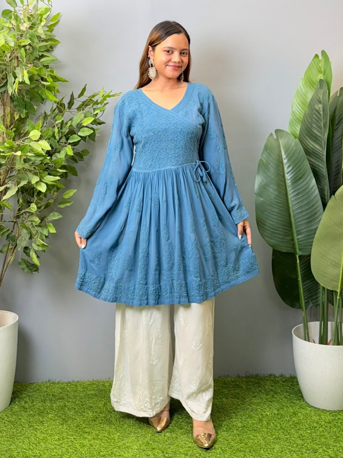 Model wearing a teal blue viscose angrakha-style short kurta with Lucknowi chikankari embroidery and side tie-up.
