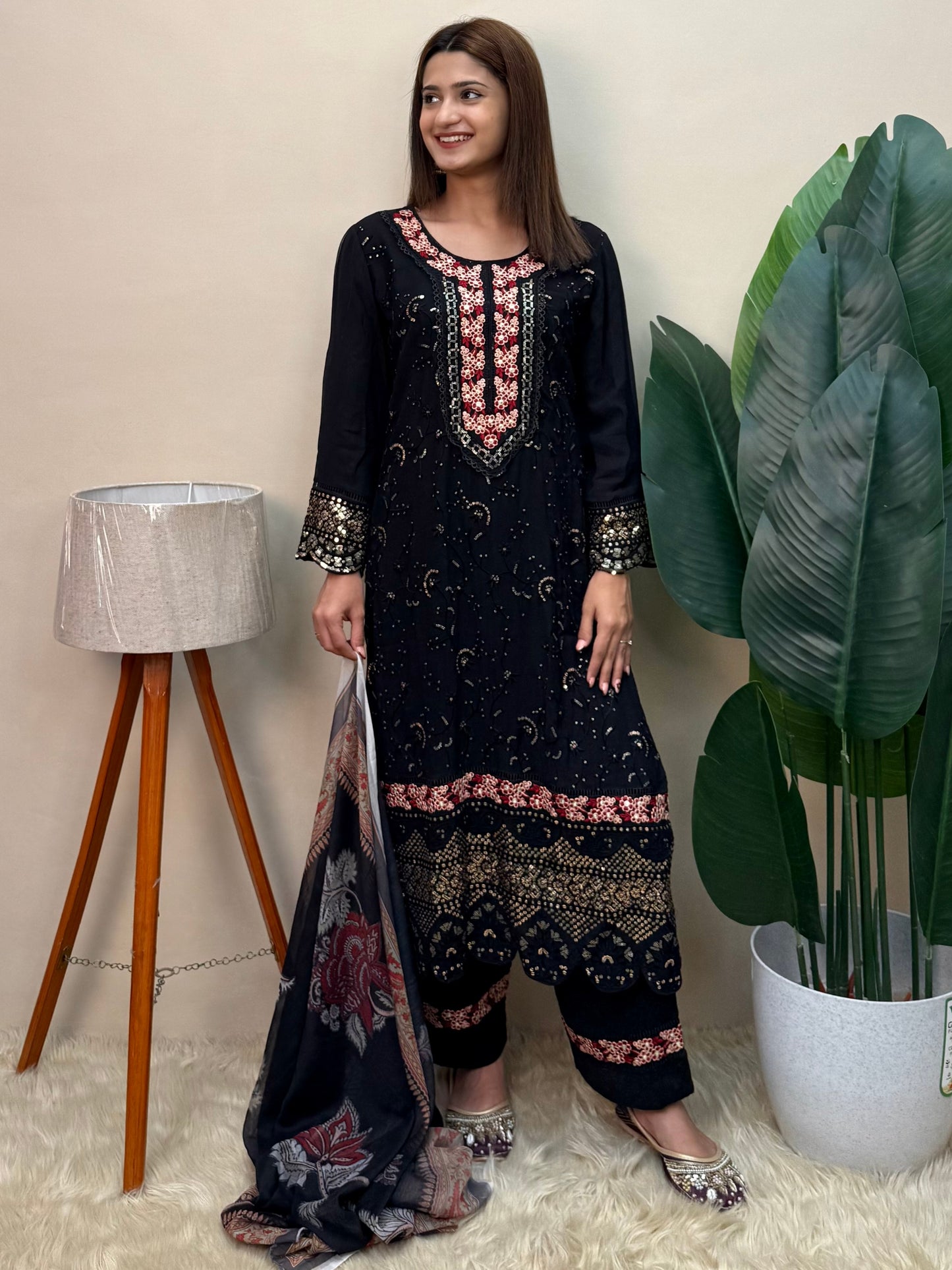 Model wearing a black rayon embroidered kurta with rayon pants and a printed chiffon dupatta – Designer Wear Collection.