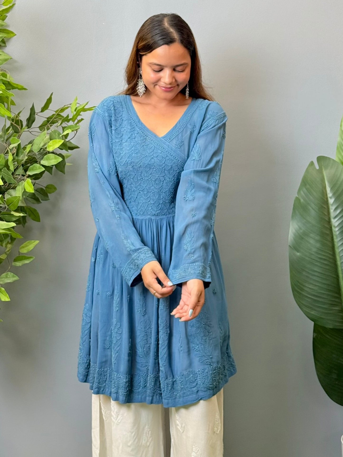 Model wearing a teal blue viscose angrakha-style short kurta with Lucknowi chikankari embroidery and side tie-up.