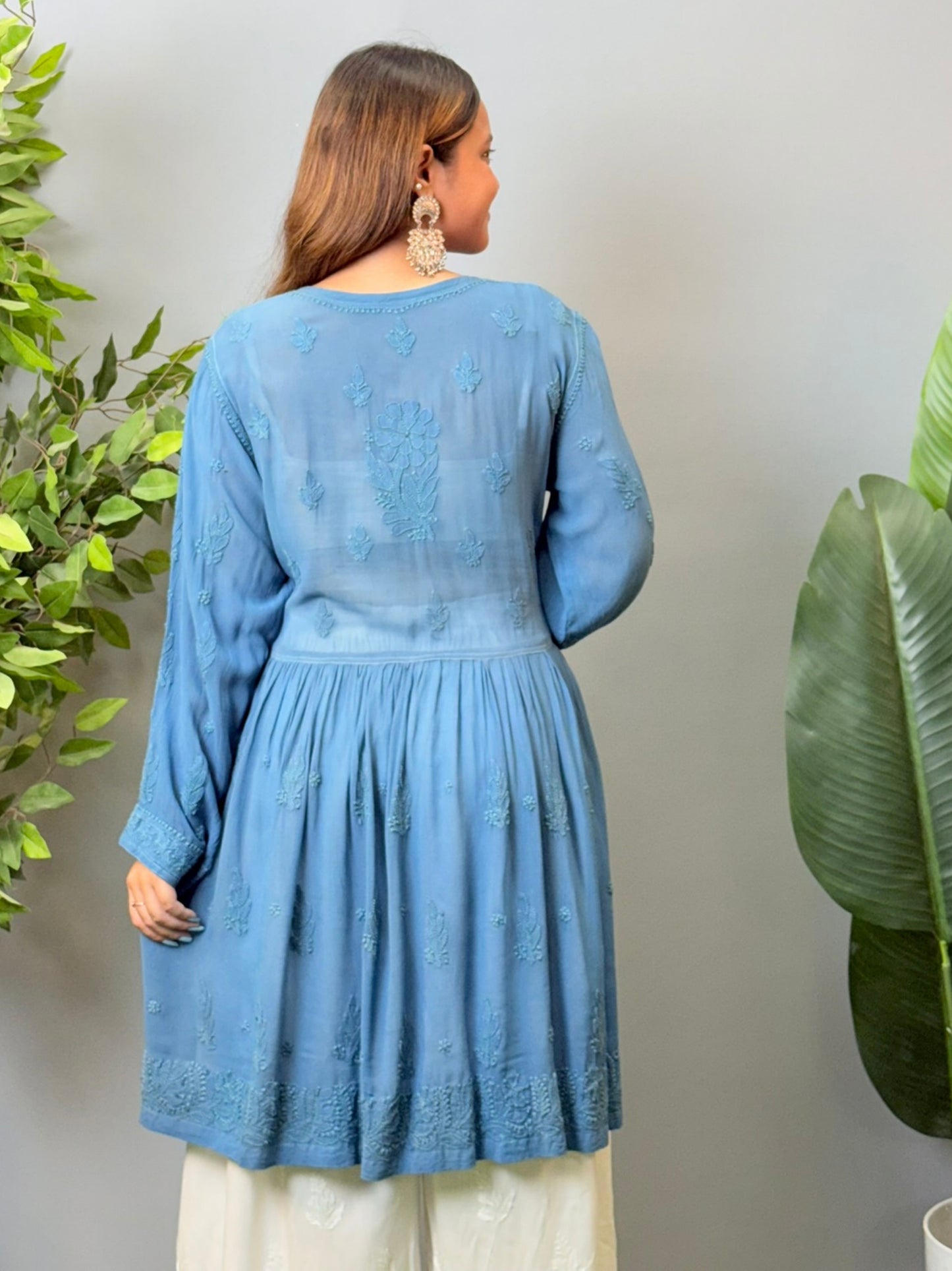 Model wearing a teal blue viscose angrakha-style short kurta with Lucknowi chikankari embroidery and side tie-up.