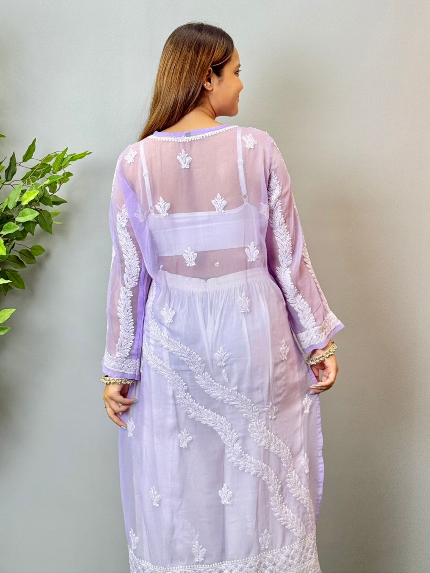 Model wearing a lavender translucent georgette Lucknowi chikankari kurta with heavy hand embroidery, styled with white palazzos for a festive look.