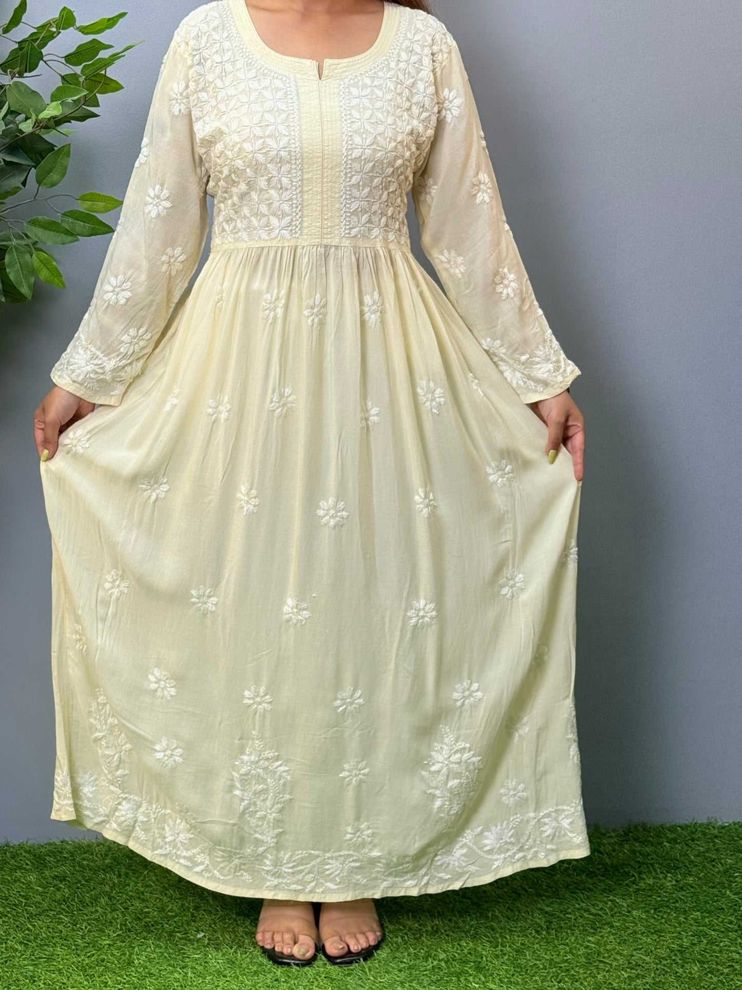 Model wearing an ivory long frock-style modal chikankari kurta with detailed embroidery