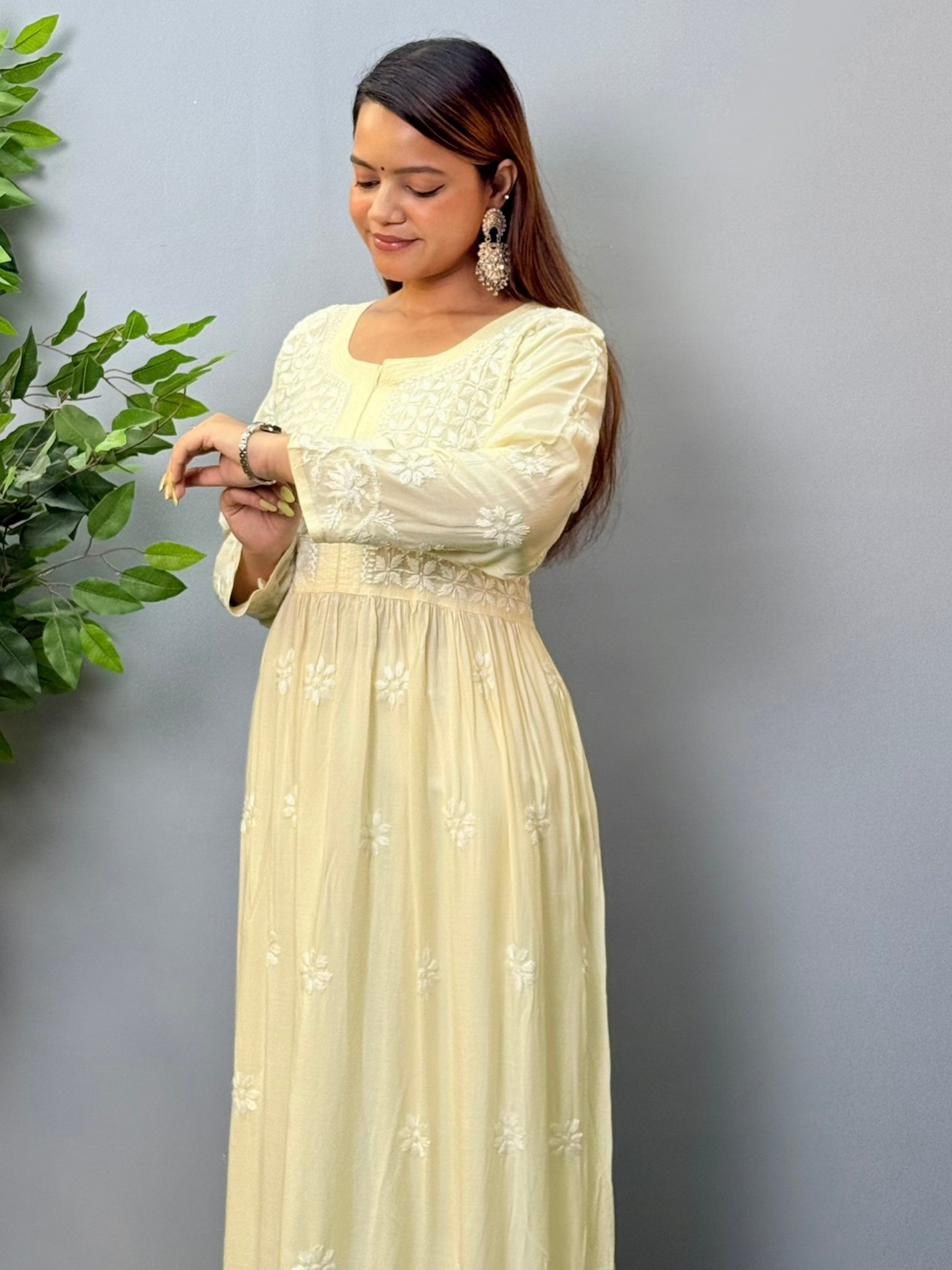 Model wearing an ivory long frock-style modal chikankari kurta with detailed embroidery