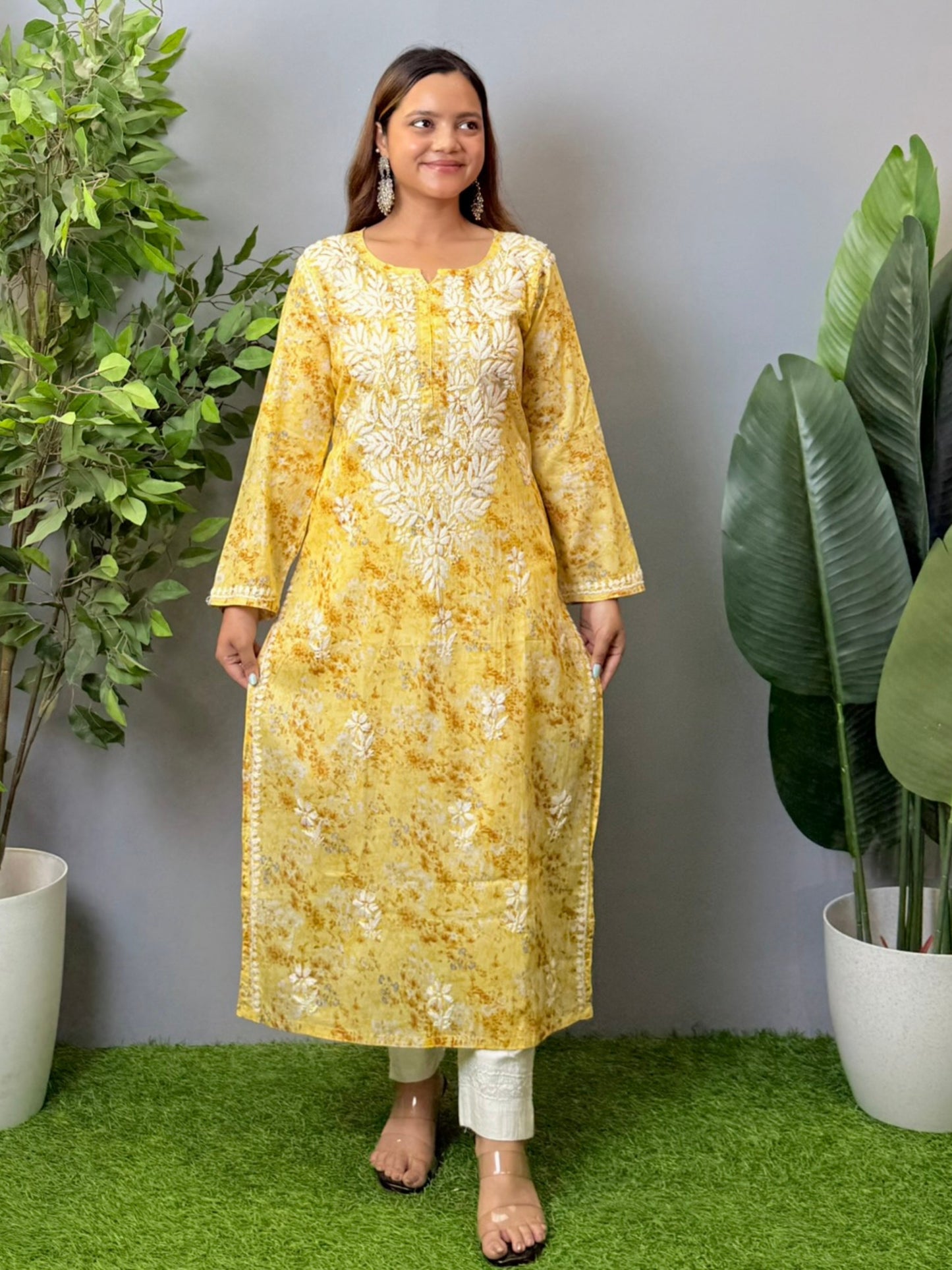 Model wearing a yellow printed mulmul chikankari kurta with white embroidery – perfect for summer