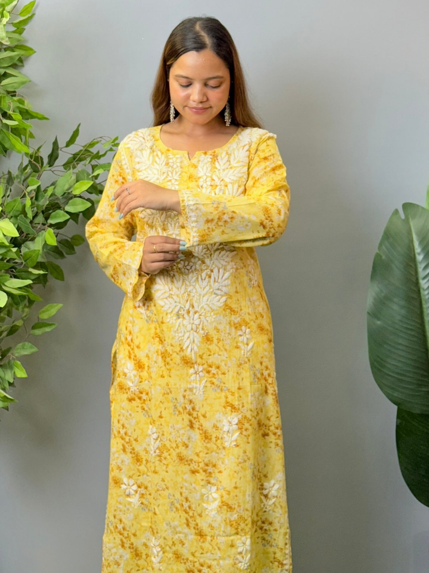 Model wearing a yellow printed mulmul chikankari kurta with white embroidery – perfect for summer