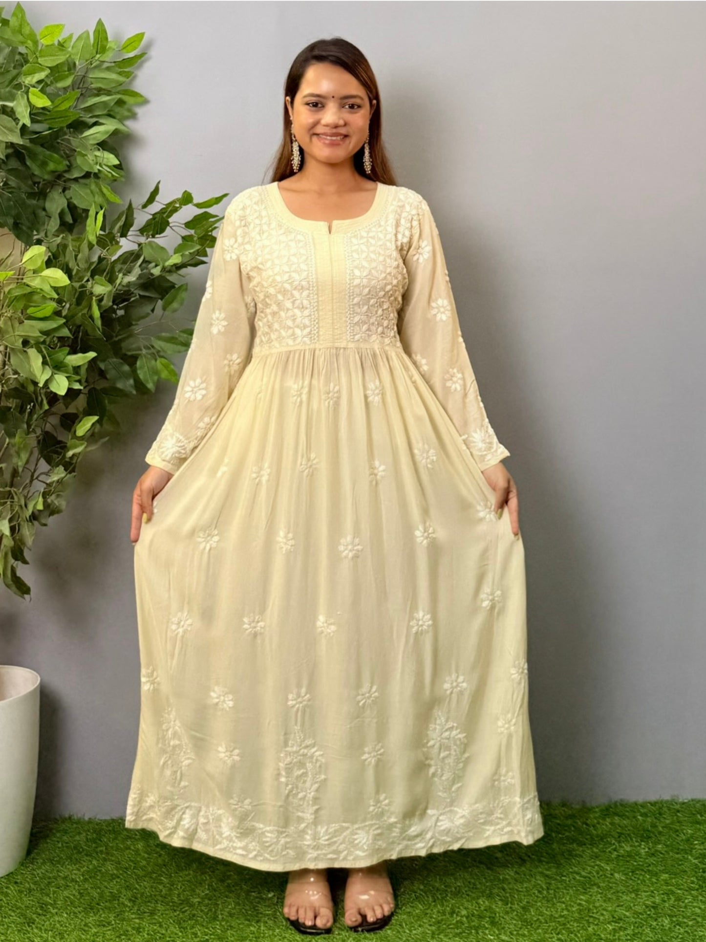 Model wearing an ivory long frock-style modal chikankari kurta with detailed embroidery