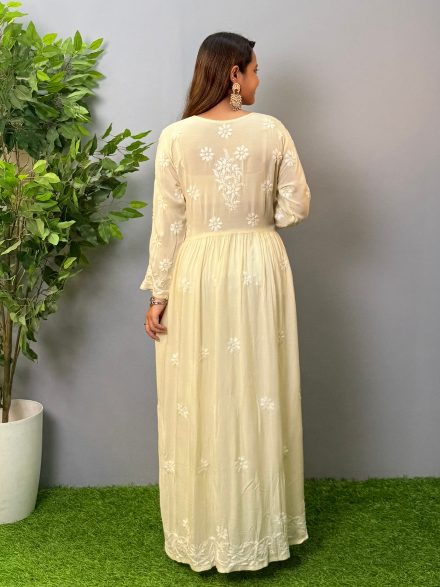 Model wearing an ivory long frock-style modal chikankari kurta with detailed embroidery