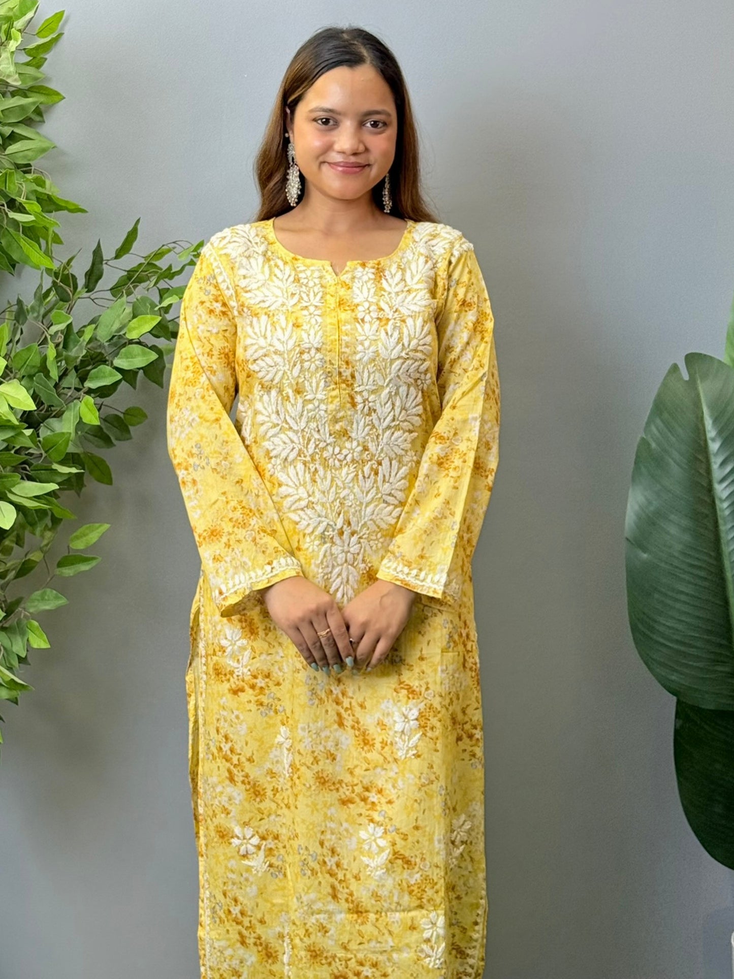 Model wearing a yellow printed mulmul chikankari kurta with white embroidery – perfect for summer