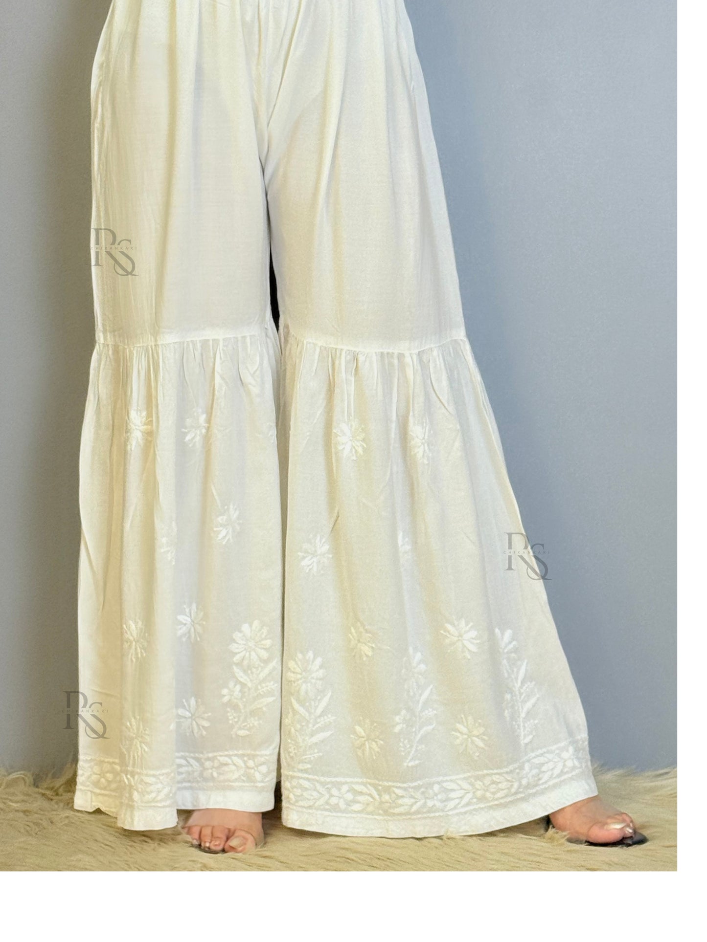 White modal chikankari sharara with flared hem and floral embroidery