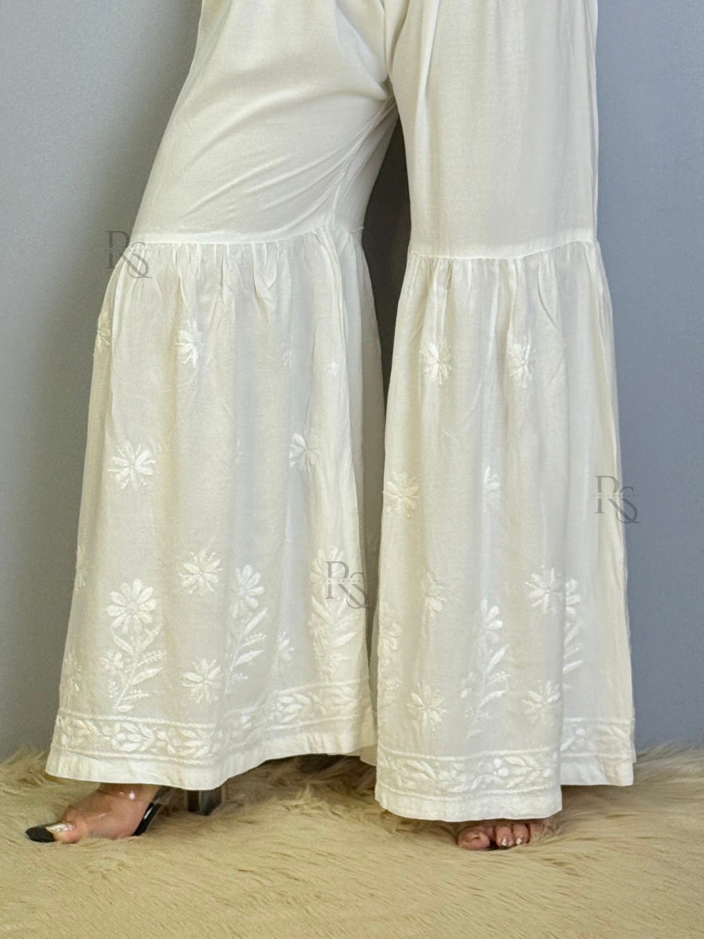 White modal chikankari sharara with flared hem and floral embroidery