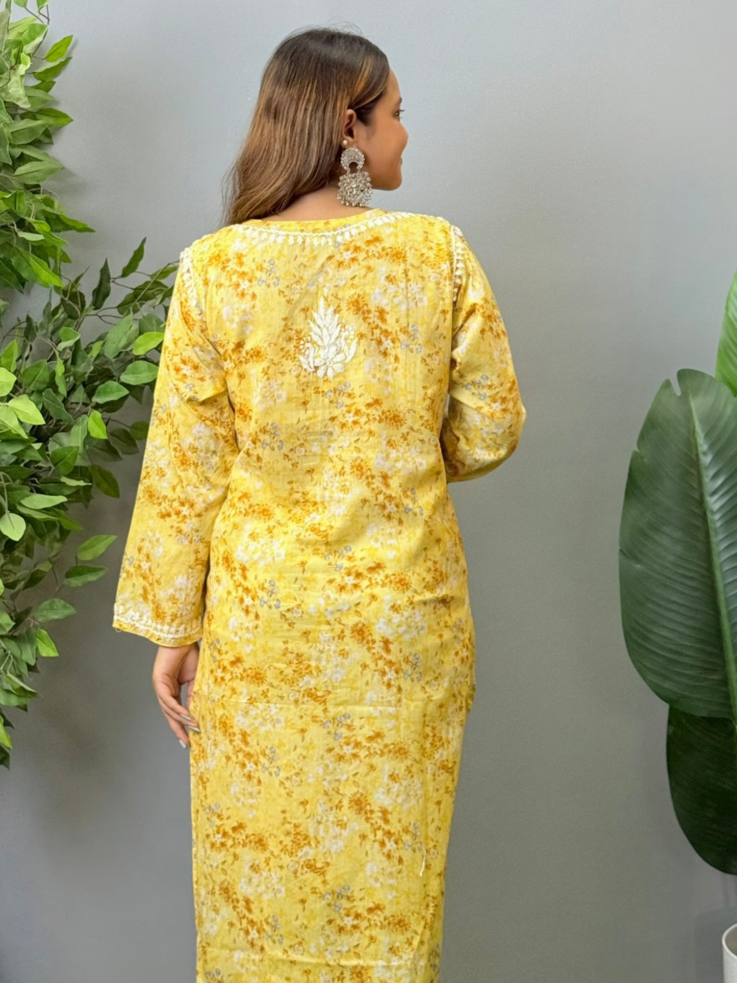 Model wearing a yellow printed mulmul chikankari kurta with white embroidery – perfect for summer