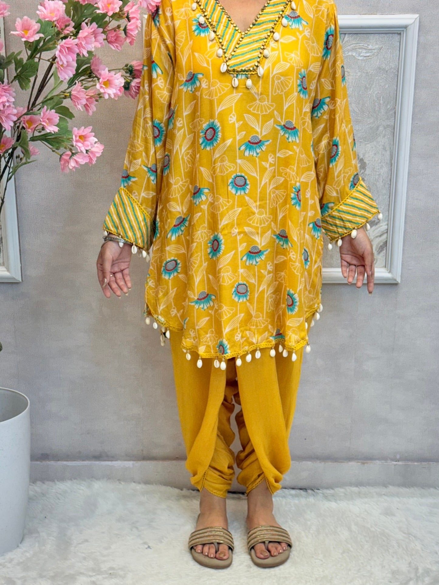 Yellow floral muslin kurta with dhoti pant set featuring shell work and printed design