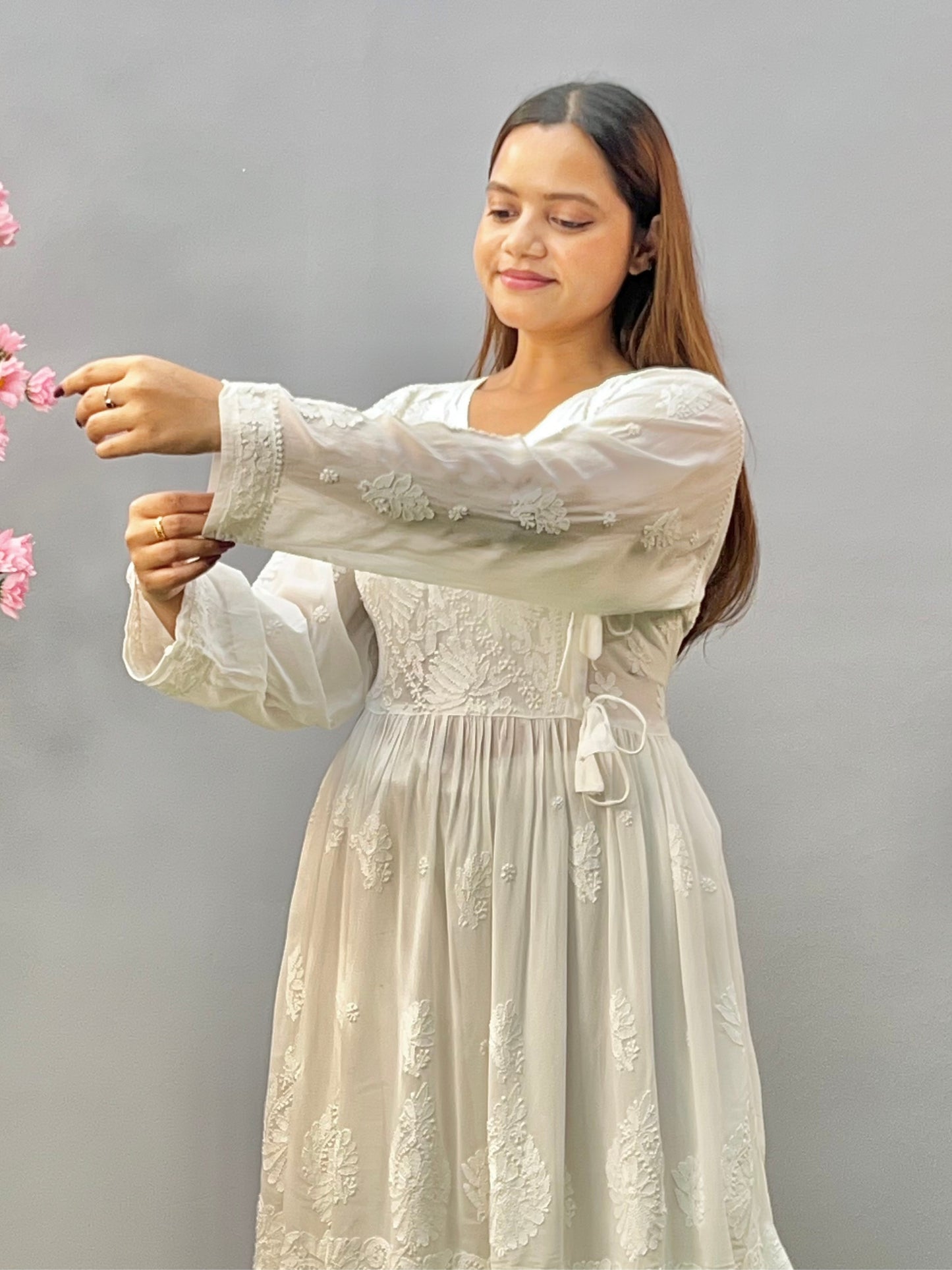 Woman wearing a premium white dyable viscose Lucknowi Chikankari short angrakha frock with full sleeves and tie-up detail, by R S CHIKANKARI.