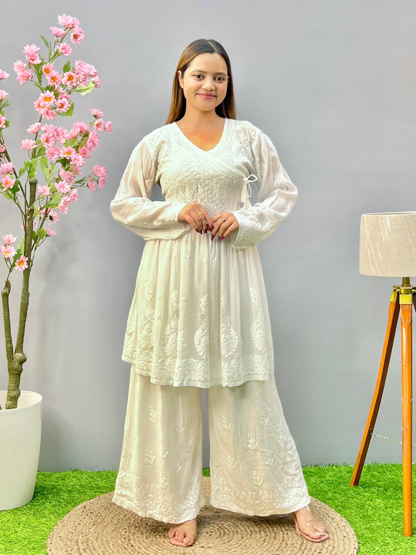 Woman wearing a premium white dyable viscose Lucknowi Chikankari short angrakha frock with full sleeves and tie-up detail, by R S CHIKANKARI.