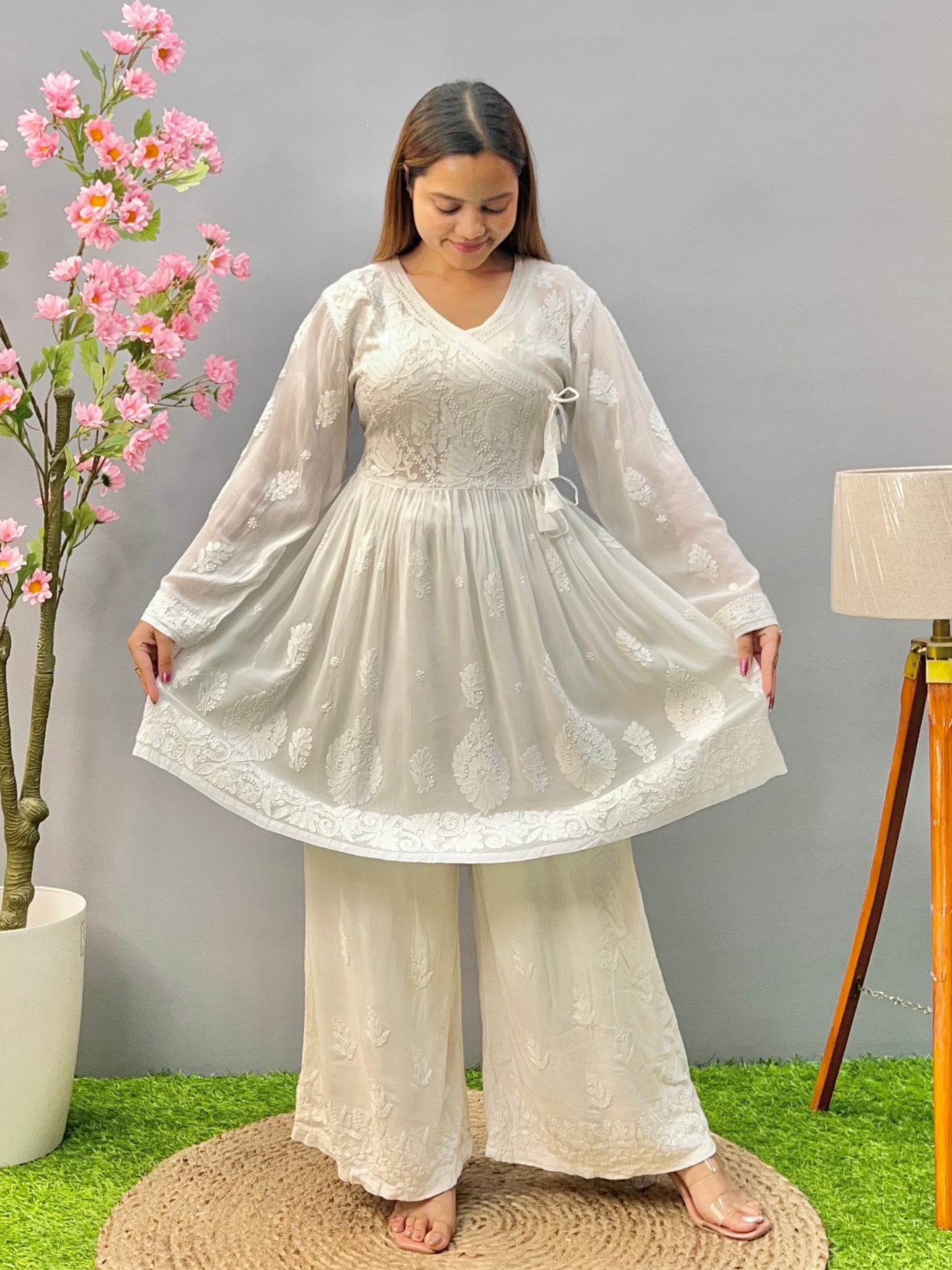 Woman wearing a premium white dyable viscose Lucknowi Chikankari short angrakha frock with full sleeves and tie-up detail, by R S CHIKANKARI.