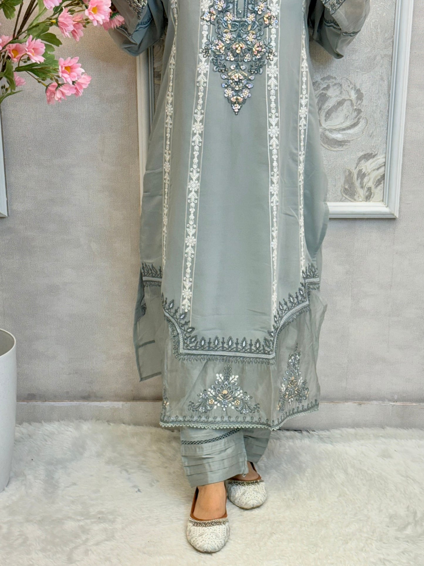Model wearing dusty blue chikankari designer suit with organza dupatta
