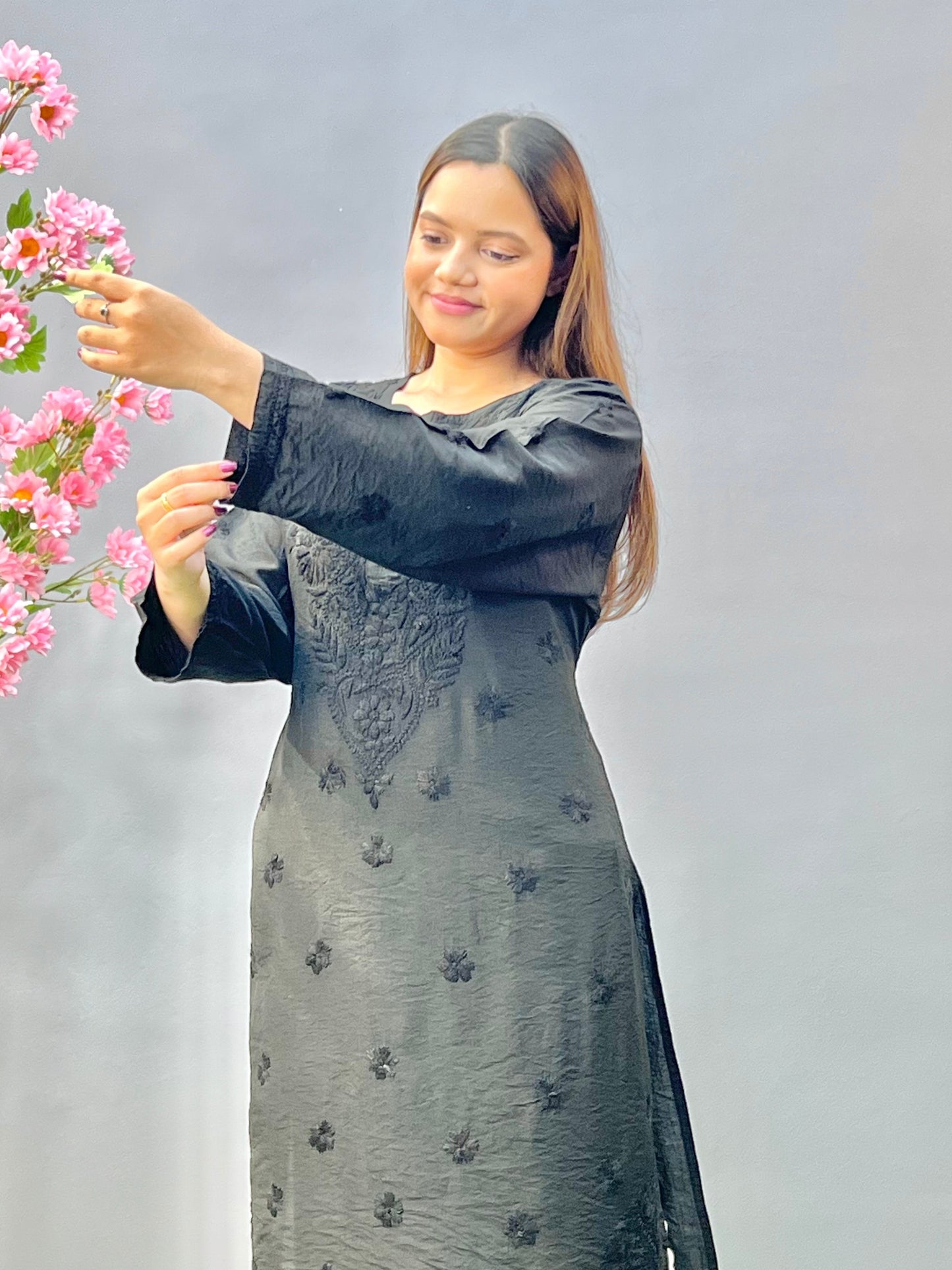 Woman wearing a premium classic black Chanderi Lucknowi Chikankari straight cut kurta with tone-on-tone embroidery, full sleeves, by R S CHIKANKARI.