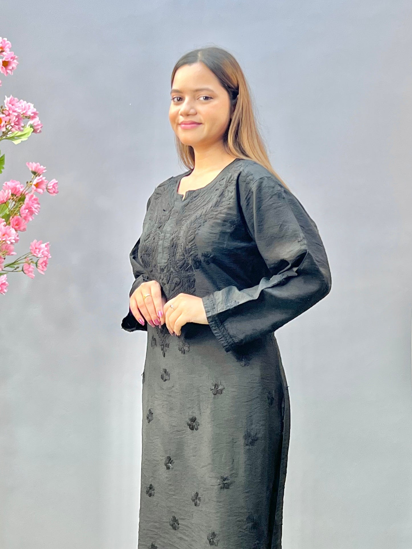 Woman wearing a premium classic black Chanderi Lucknowi Chikankari straight cut kurta with tone-on-tone embroidery, full sleeves, by R S CHIKANKARI.