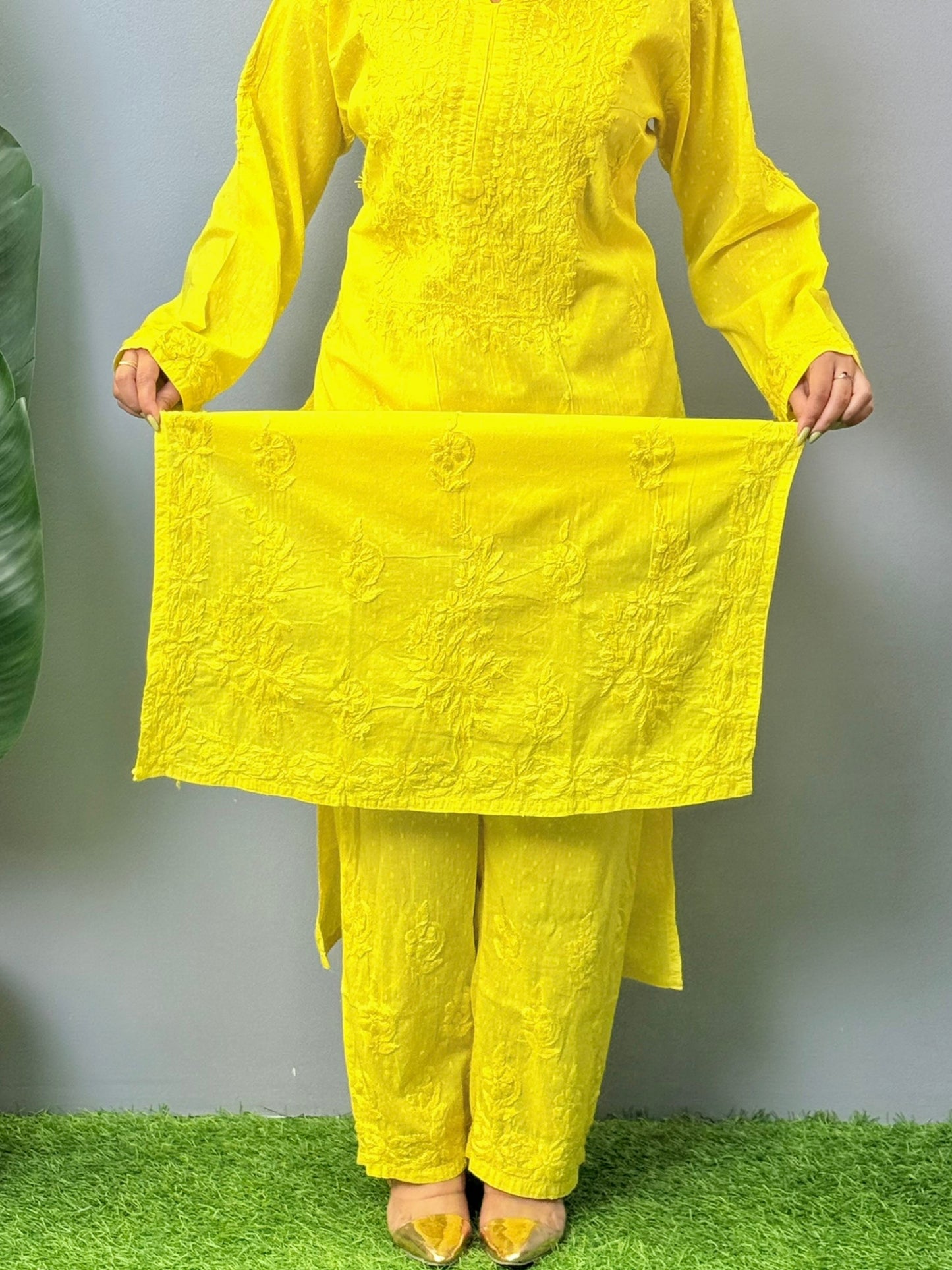 Model wearing bright yellow dobby cotton chikankari kurta and pant set